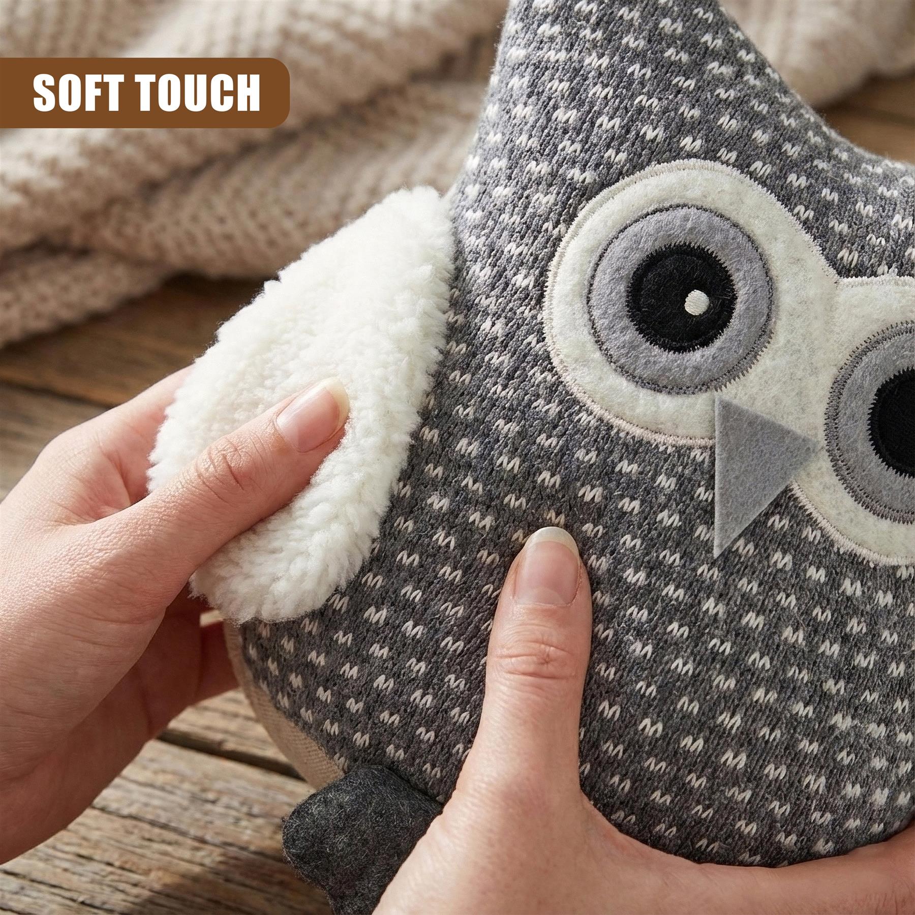 A plush owl toy with a soft, grey and white tweed-like fabric, featuring large, round, grey eyes and a grey beak. The owl is held by a hand, with a soft, white, fuzzy ear being touched by another hand. - The Magic Toy Shop