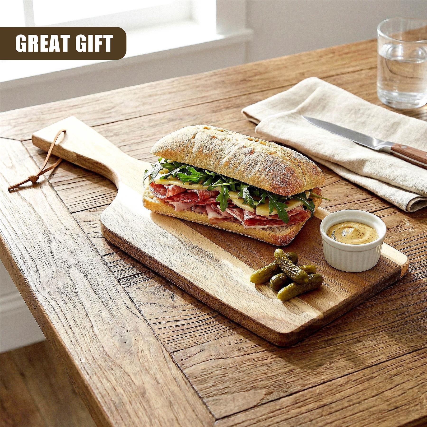 Sandwich, pickles, and mustard sauce are arranged on a wooden paddle chopping board.