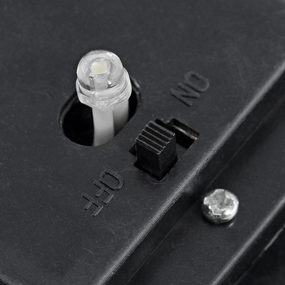 A black housing shows an electrical receptacle and a toggle switch labeled ON and OFF.