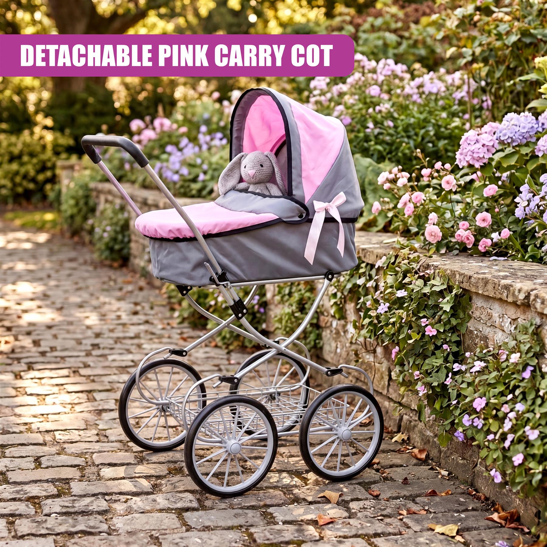 Baby pram featuring a pink canopy and gray carriage body, positioned on cobblestones.