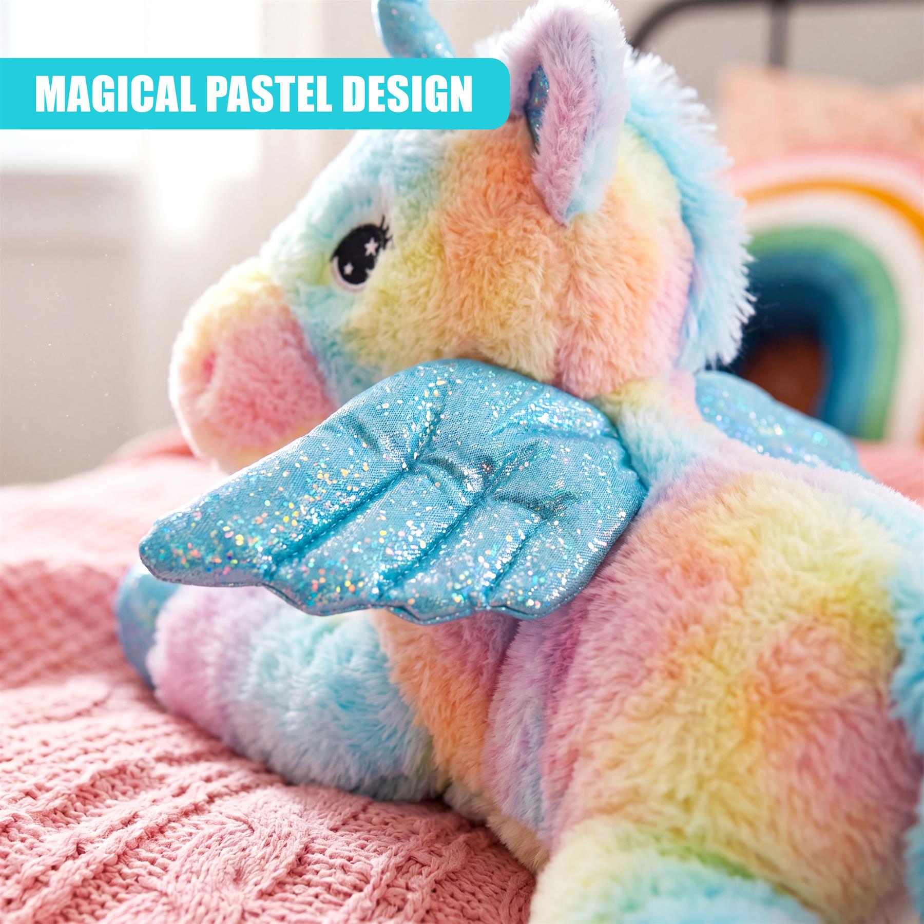 Soft plush unicorn toy featuring rainbow-colored fur and large glittery blue wings.