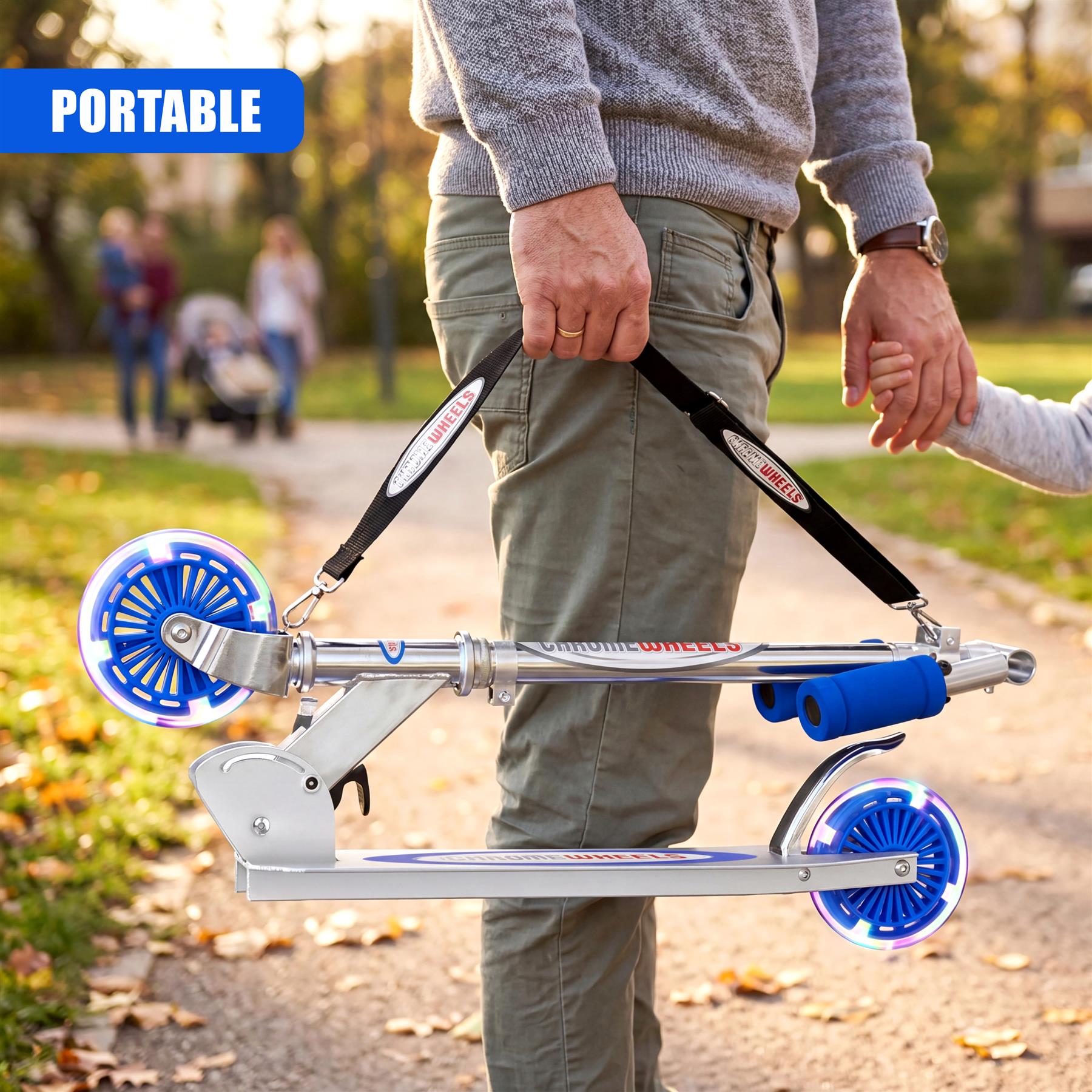 Collapsible blue scooter featuring two large wheels and a silver metal deck carried by a person.