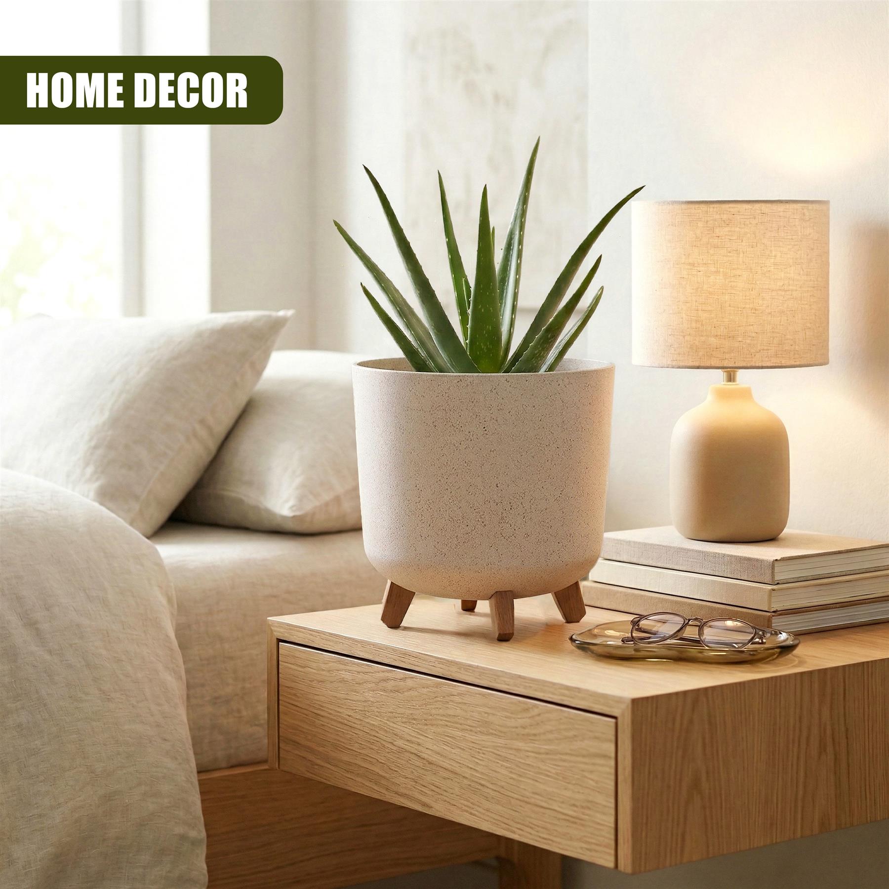 Ceramic plant pot with legs holds spiky leaves on a dresser beside a table lamp.