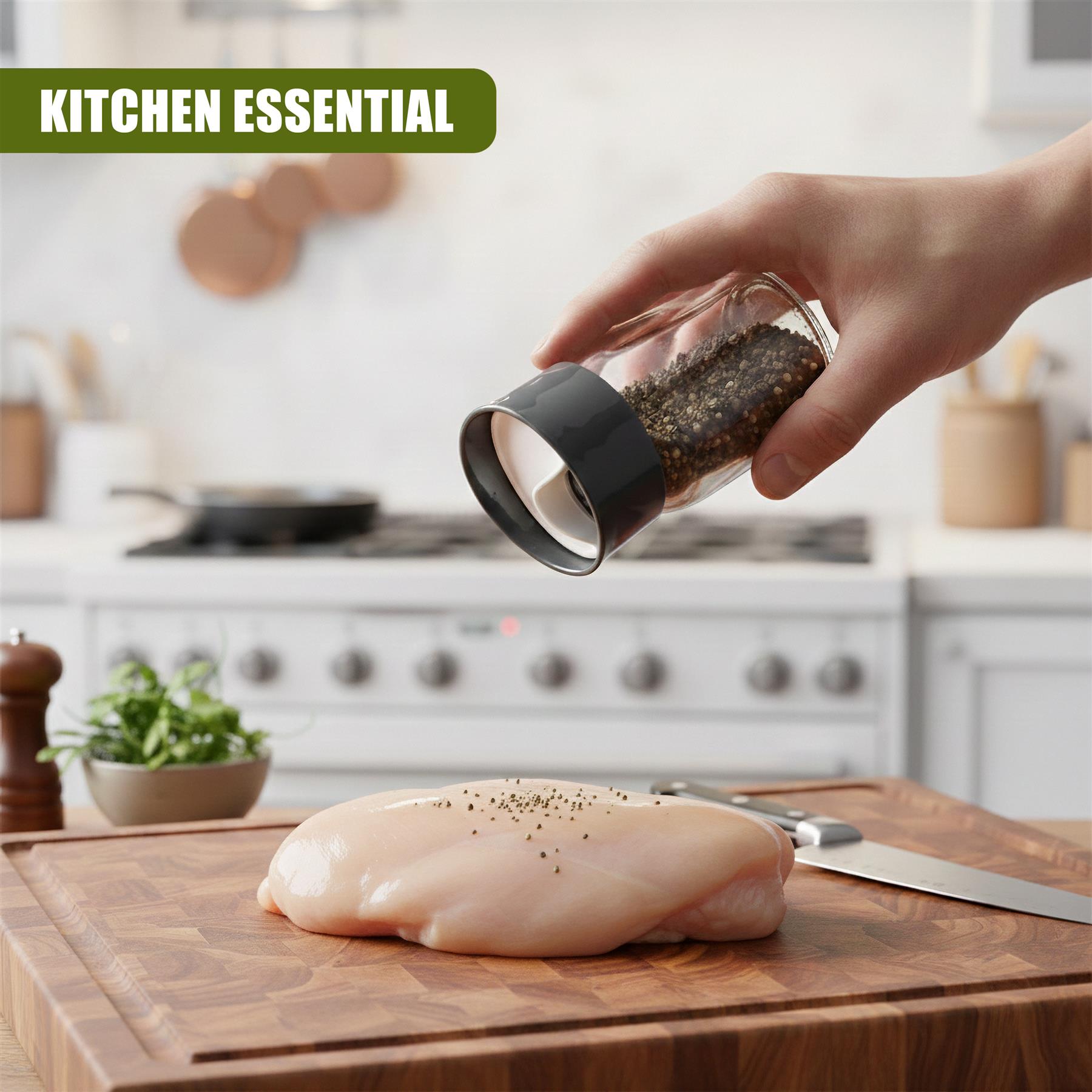 Hand sprinkling pepper from a clear glass shaker onto a raw chicken breast on a cutting board.