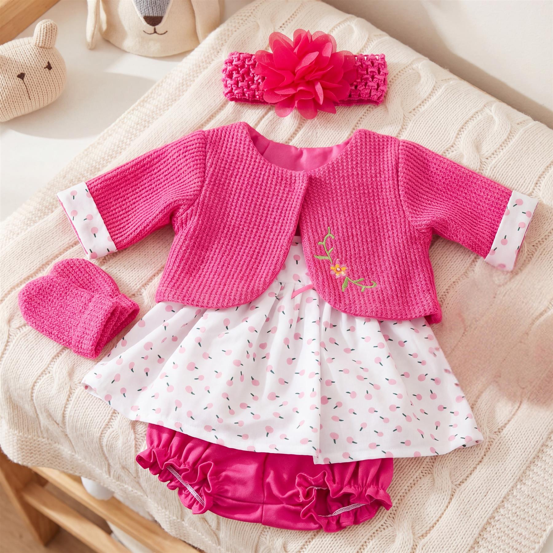 Hot pink knitted doll top, polka-dot skirt, and matching ruffled bottoms are shown together.