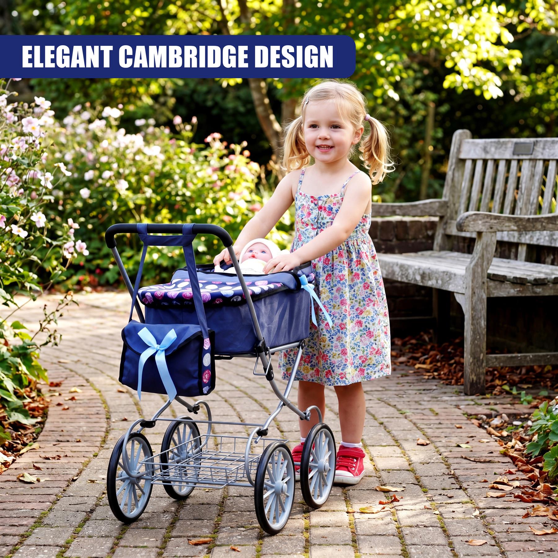 Girl in floral dress stands with a blue and metal doll pram outdoors on a paved garden path.