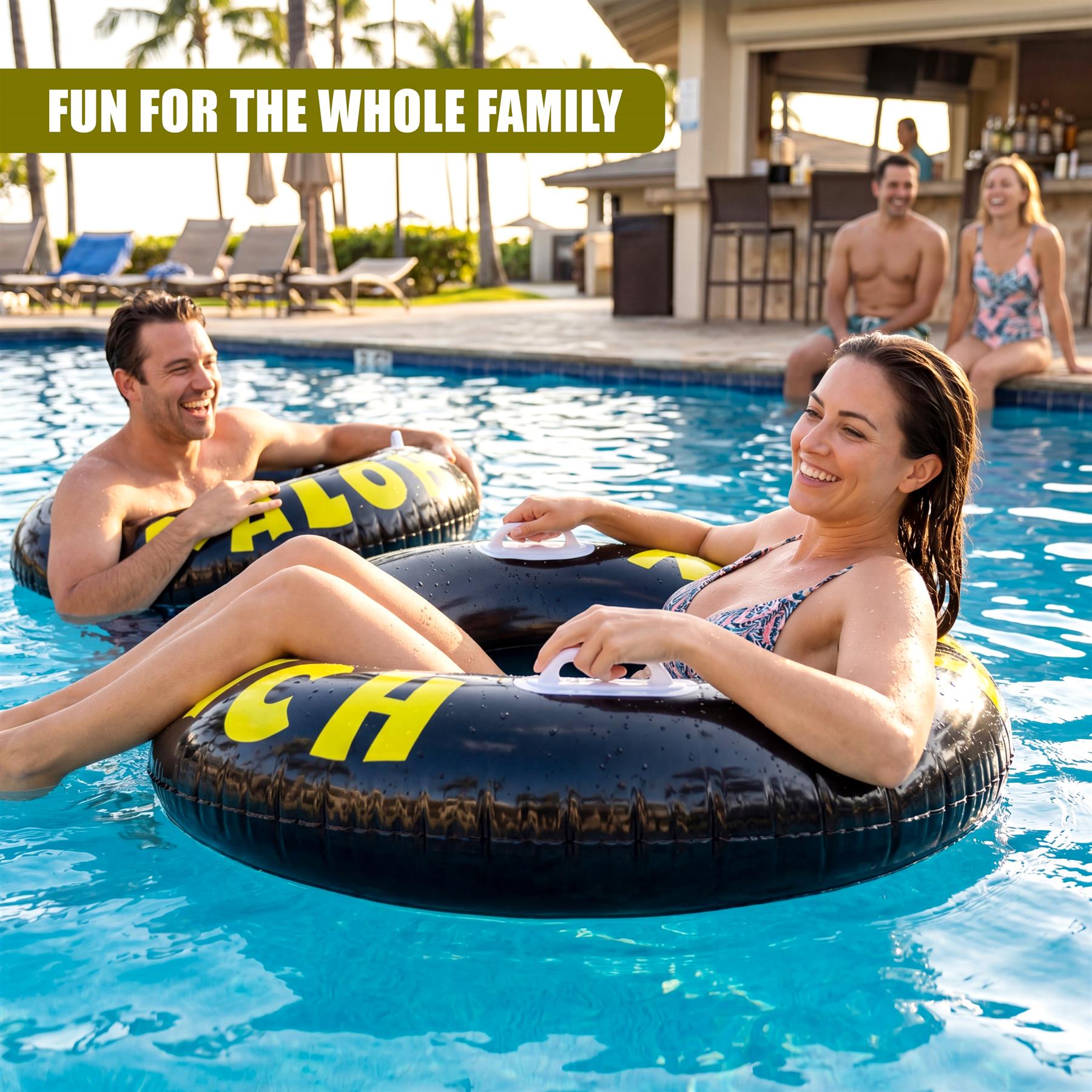 Black inflatable tire ring with yellow lettering floats on bright blue pool water.