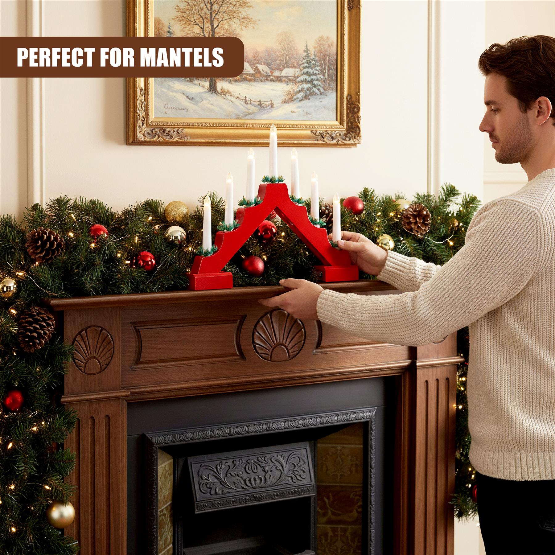 A man places a red, wooden, 7-arm candelabra on a decorated mantel, surrounded by Christmas decorations and a painting. - The Magic Toy Shop