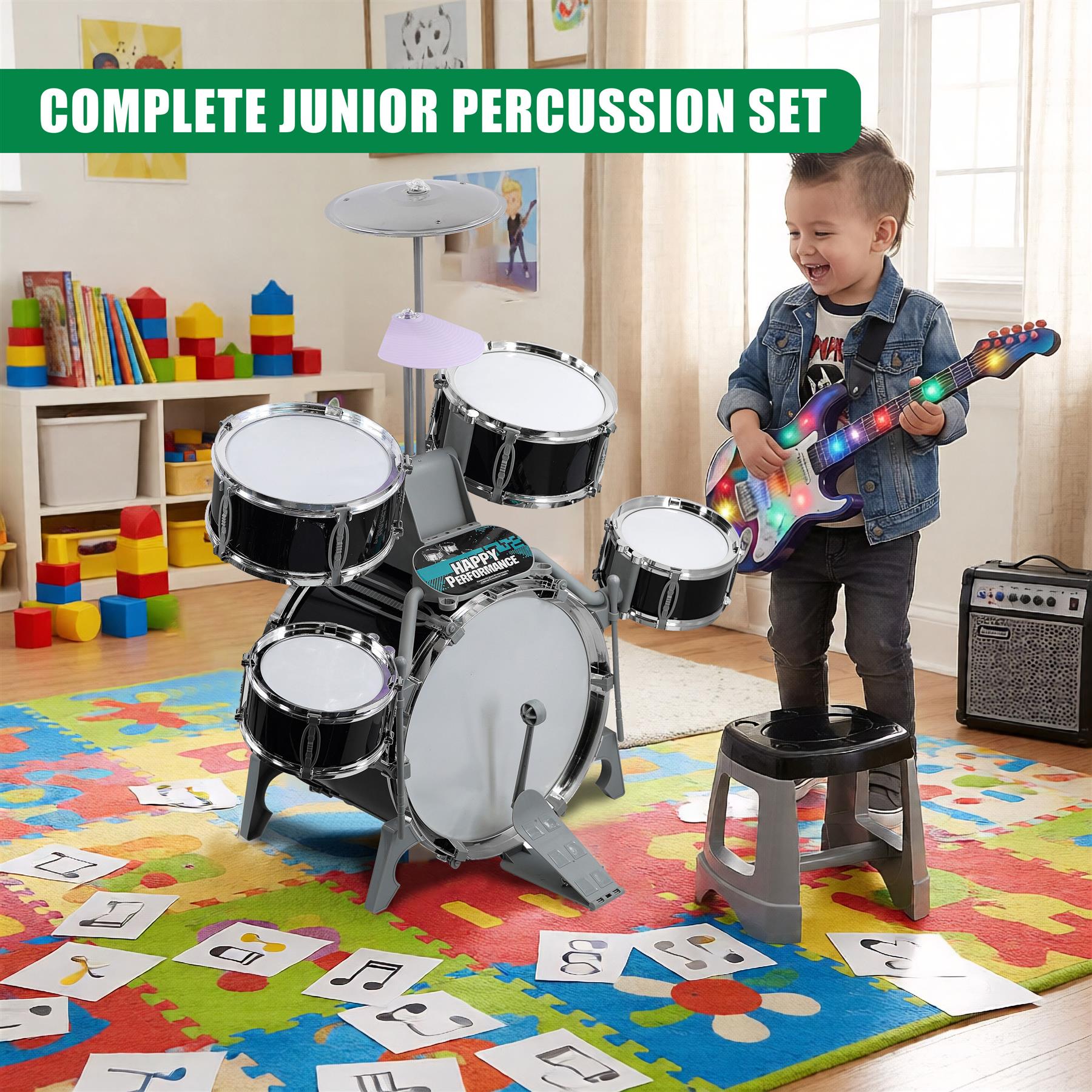 A child is playing with a toy drum set in a room with a rug, toy blocks, and a bookshelf. The drum set has five drums and cymbals, and a stool. The child is holding a toy guitar with flashing lights. The room is well-lit and has a white wall with framed pictures. - The Magic Toy Shop