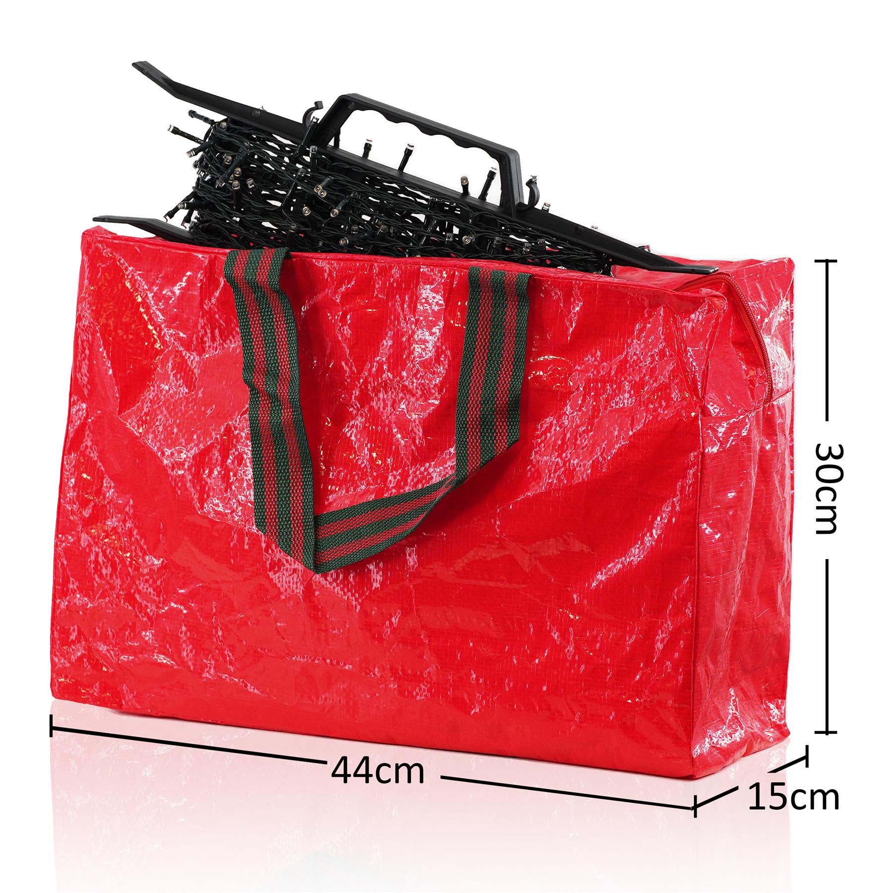A large, red, rectangular-shaped storage bag with a green and red striped handle, made of a shiny, plastic-like material. The bag is filled with a black, metal, wire-like object. - The Magic Toy Shop