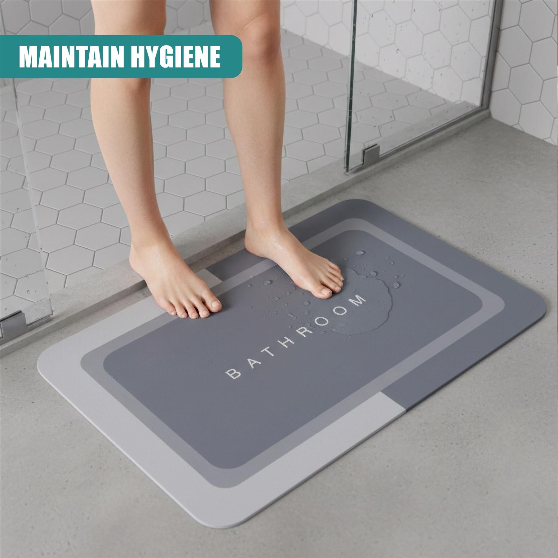 Grey rectangular anti-slip mat with embossed word "BATHROOM" on a tile floor.