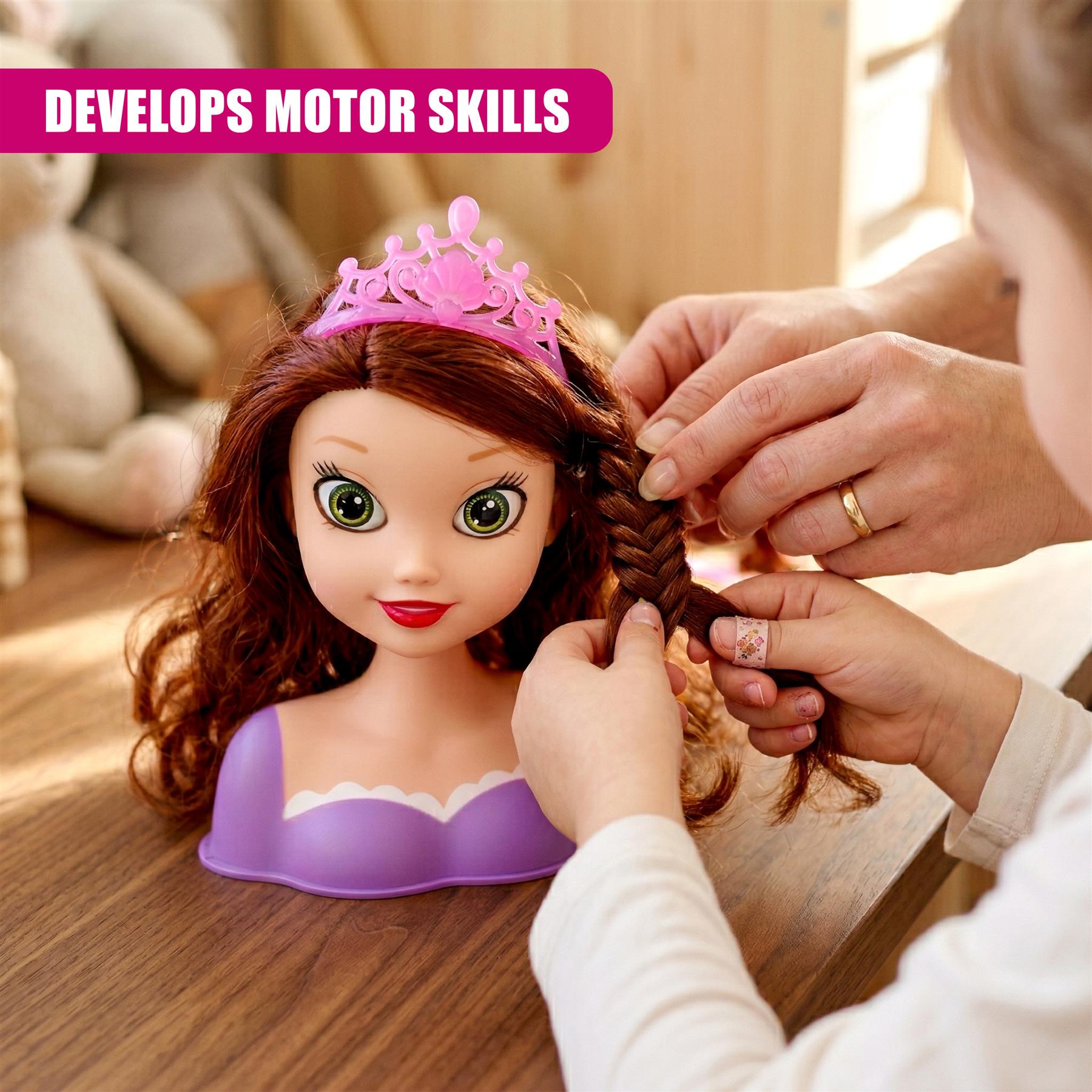 Hands are braiding the brown hair of a doll head resting on a wooden surface.