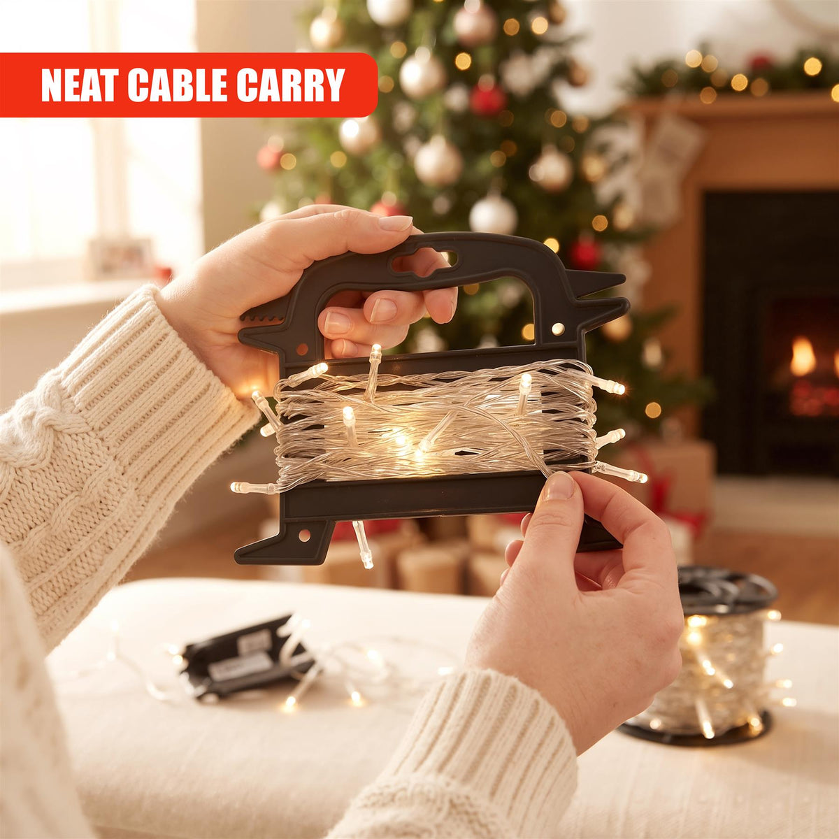 A person holds a GEEZY Christmas light reel storage with illuminated fairy lights