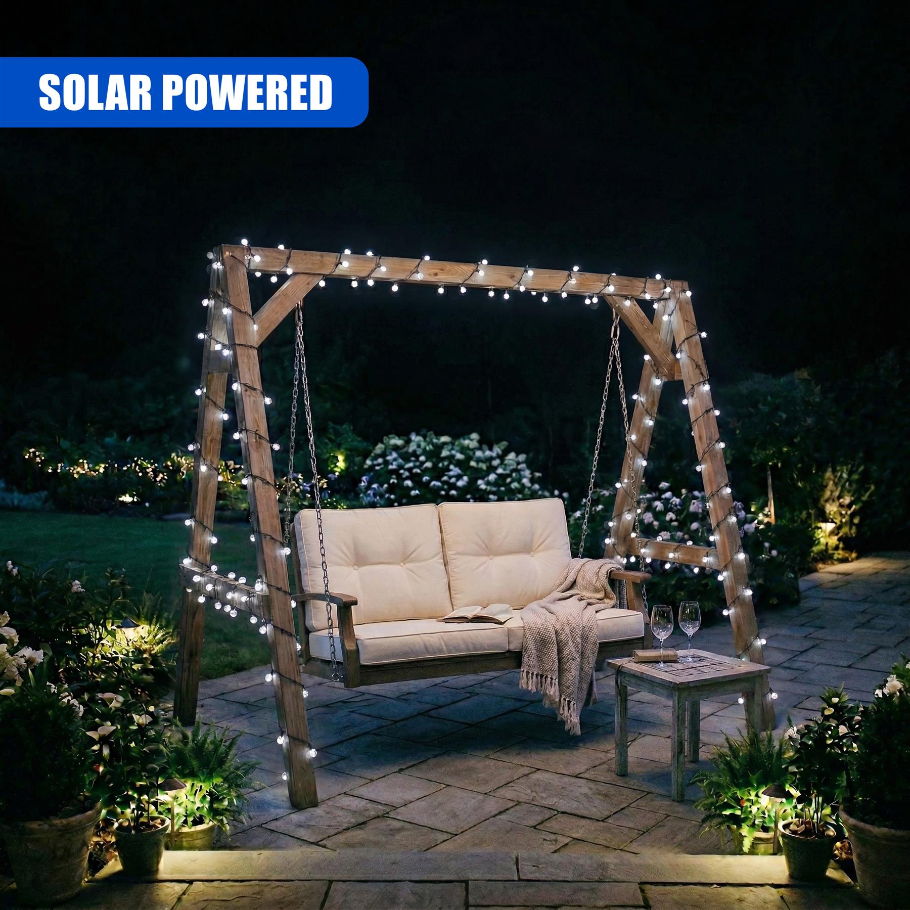 Wooden archway featuring warm string lights, a cushioned swing bench, and a small side table on a patio.