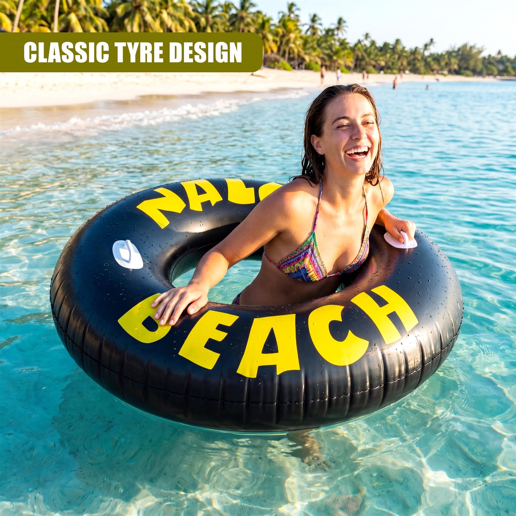 Large black inflatable ring with yellow lettering floats in clear, tropical ocean water.