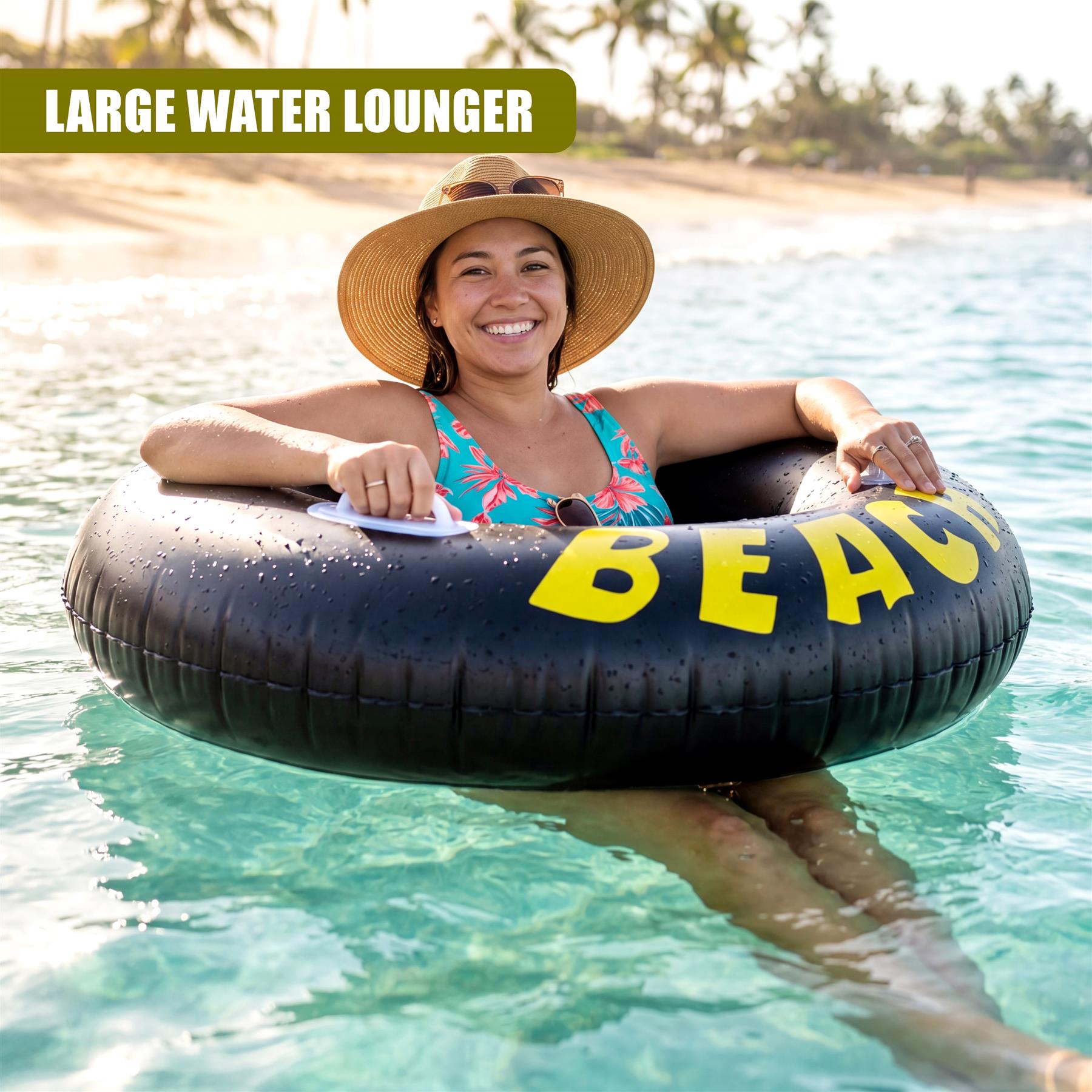 Black inflatable ring with yellow lettering floats on the surface of calm, clear water.