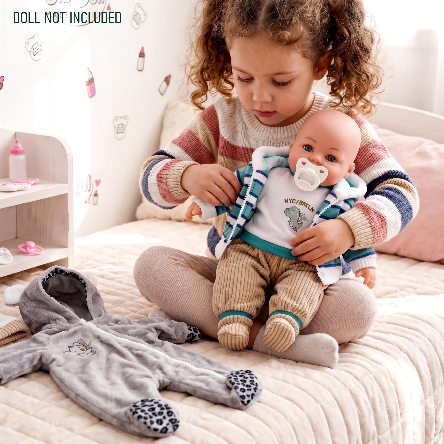 Gray koala sleeper and blue striped doll outfit are shown with a doll and child.