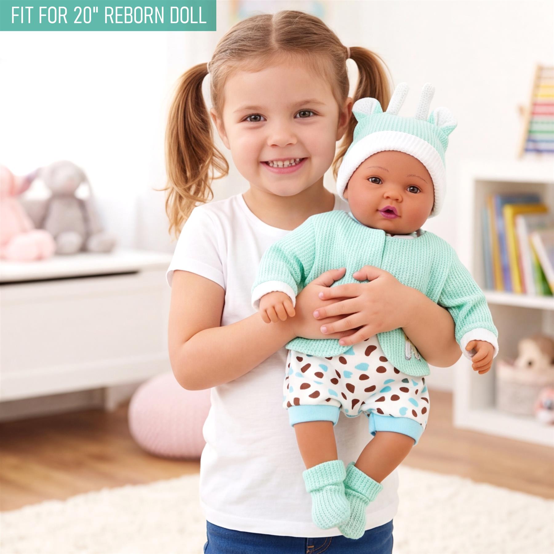 Mint green jacket and patterned outfit shown on a reborn doll held by a young girl.