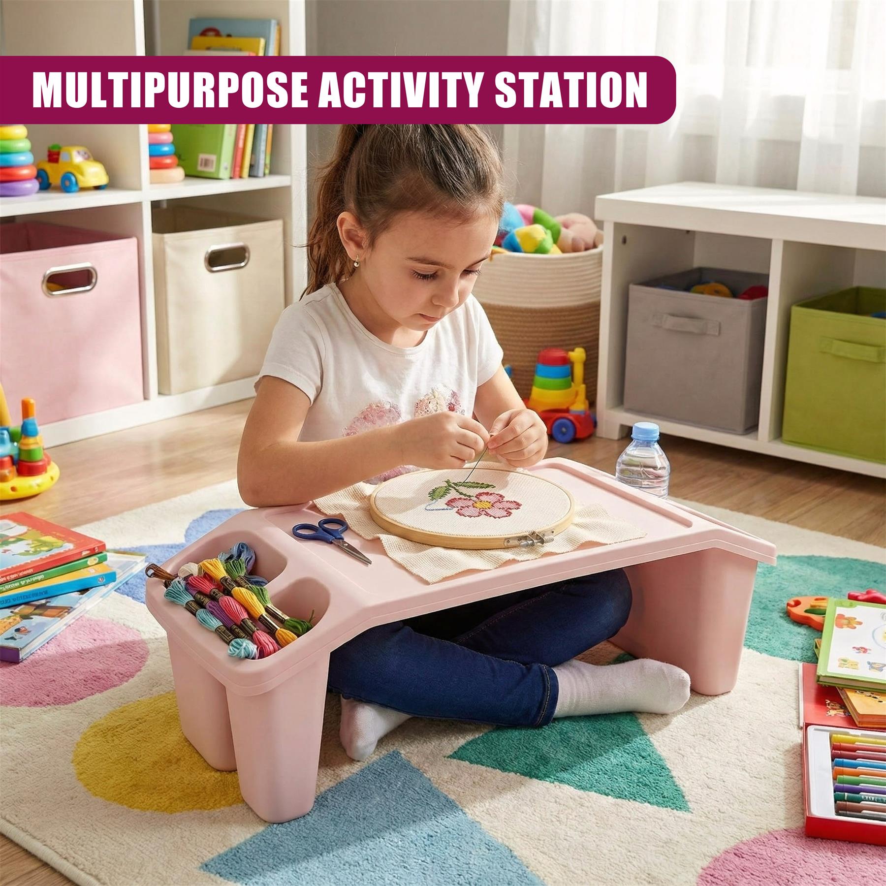 A young girl sits on a colorful rug, surrounded by toys and crafts, using a pink activity table to create a flower design with embroidery floss and a hoop. The table has a storage compartment for supplies and a tray for holding projects. - The Magic Toy Shop