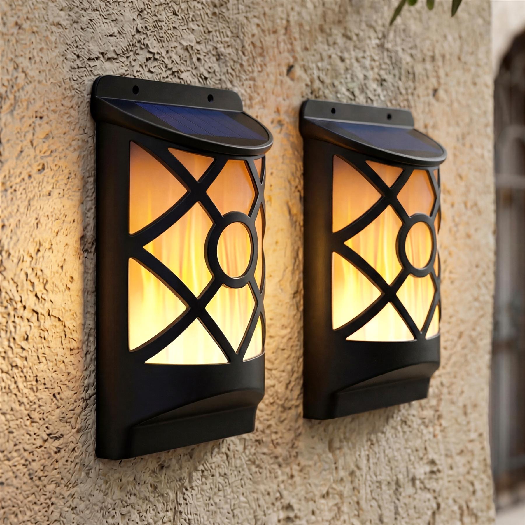 Two black, rectangular wall lanterns with decorative lattice patterns mounted on a textured stucco wall.