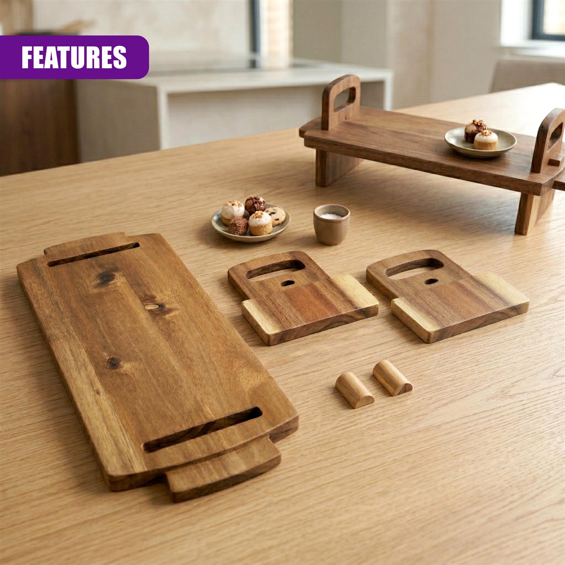 Various acacia wood serving boards, a slotted platter, and small dishes rest on a wooden surface.