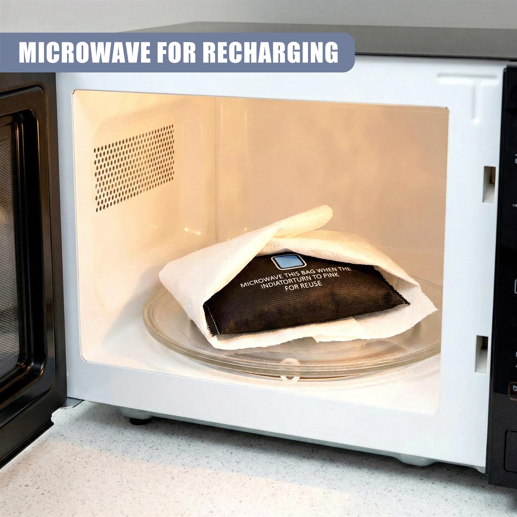 Black bag on a glass turntable placed inside an open microwave appliance for recharging.
