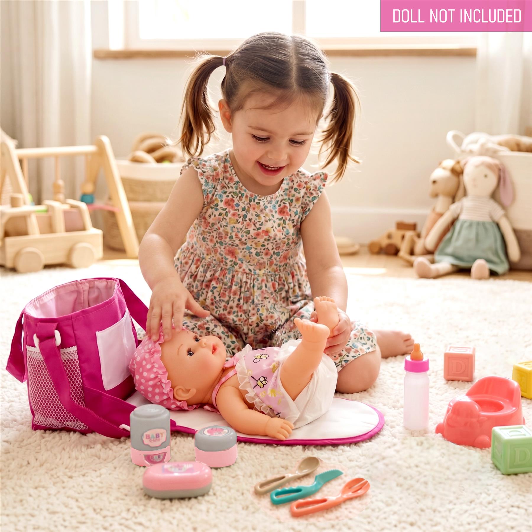 Set of baby accessories including a pink bag, doll, bottles, creams, and small plastic utensils.