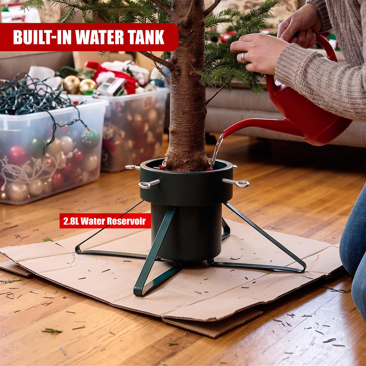 A person waters a tall Christmas tree with a red watering can, using a stand with a built-in water tank