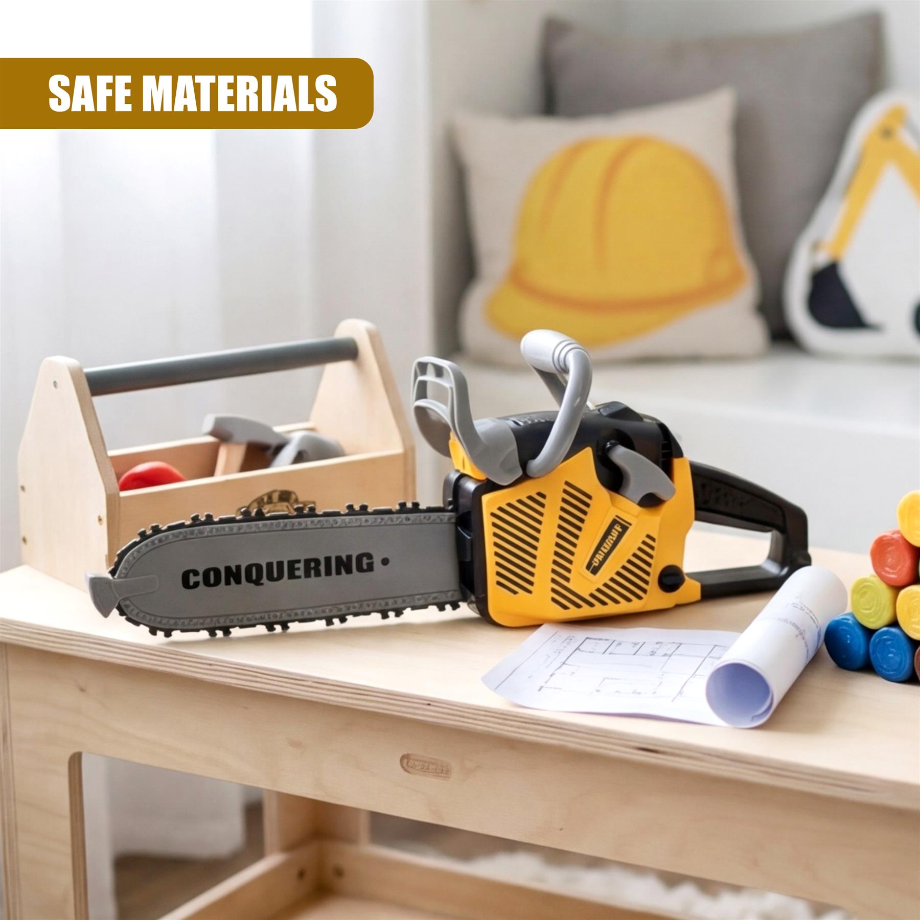Toy chainsaw and wooden toolbox displayed on a table with rolled blueprints and colorful stacking blocks.