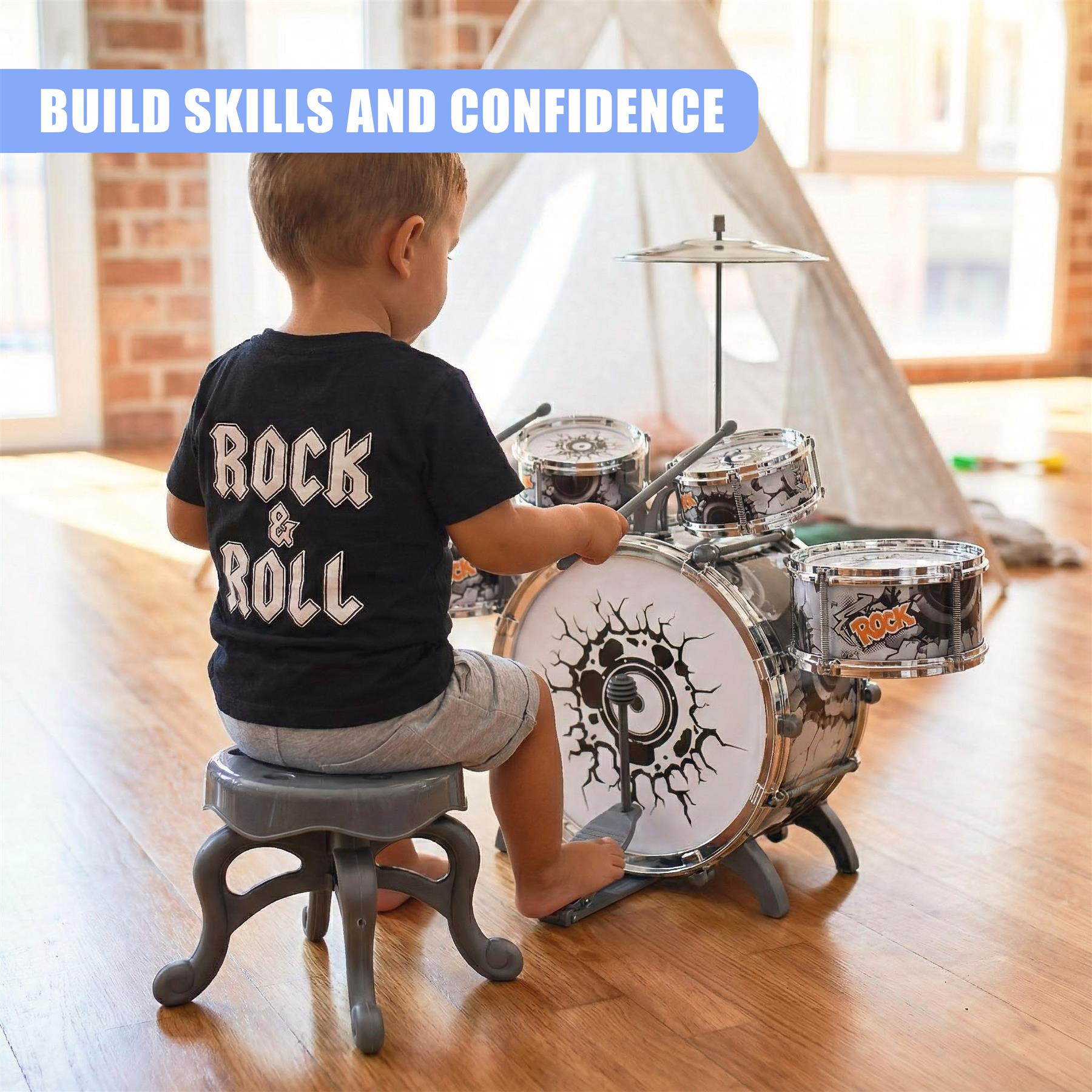 A child sits on a stool, playing a toy drum set. The drums are designed to look like a rock band's equipment, with a drum set, cymbals, and a drum throne. The child is barefoot and wearing a black t-shirt with "Rock & Roll" written on the back. The room is sunny and has a few toys and a tent in the background. - The Magic Toy Shop
