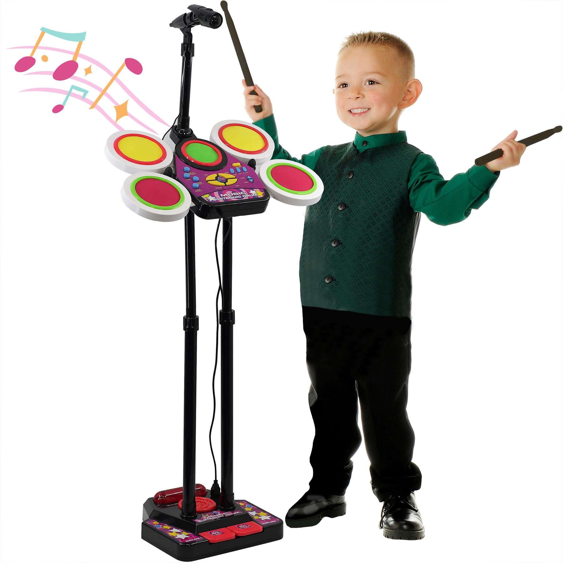 A young boy smiles while playing a multi-colored electronic drum kit with drumsticks.