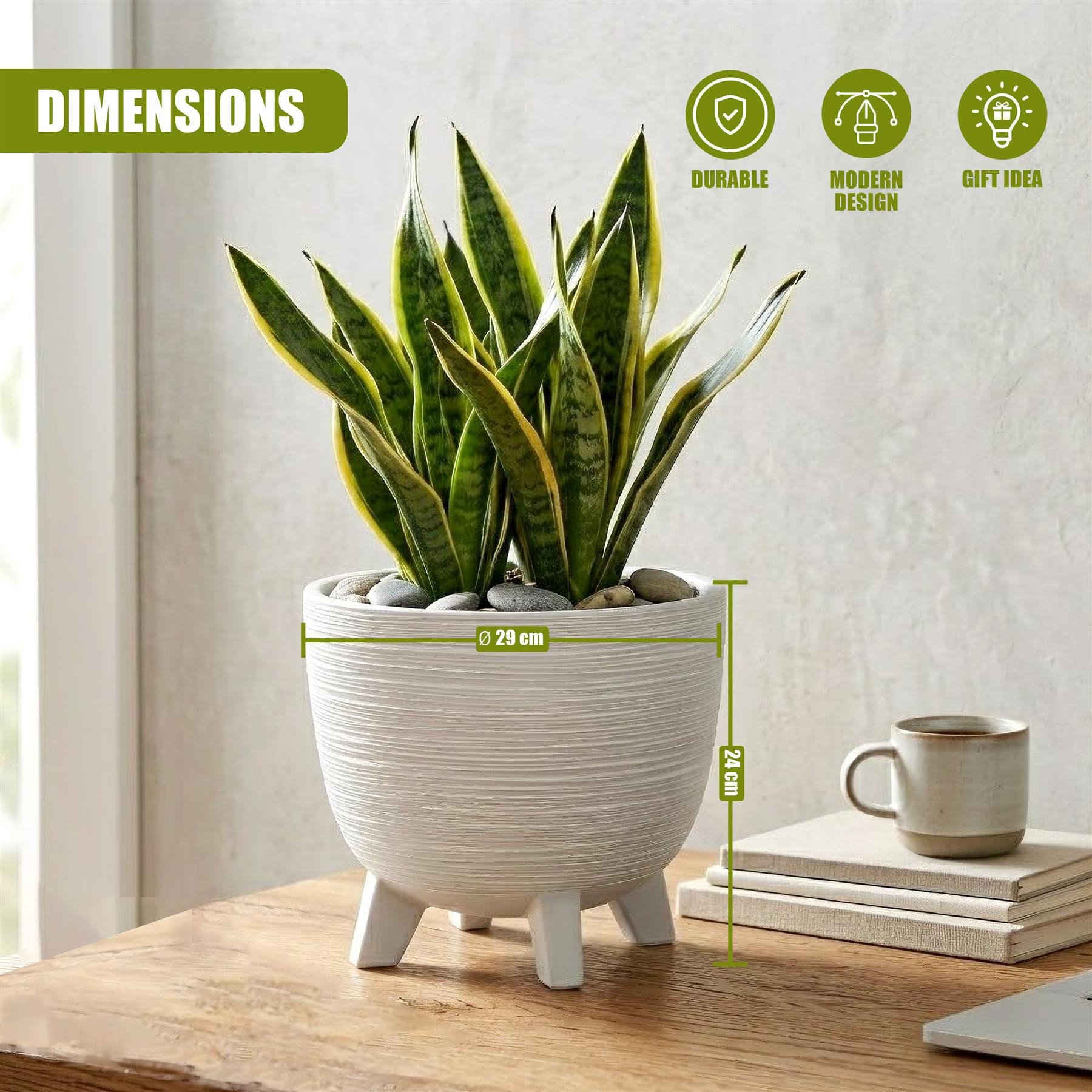 White, textured flower pot with legs holding a vibrant snake plant and decorative pebbles on wood.