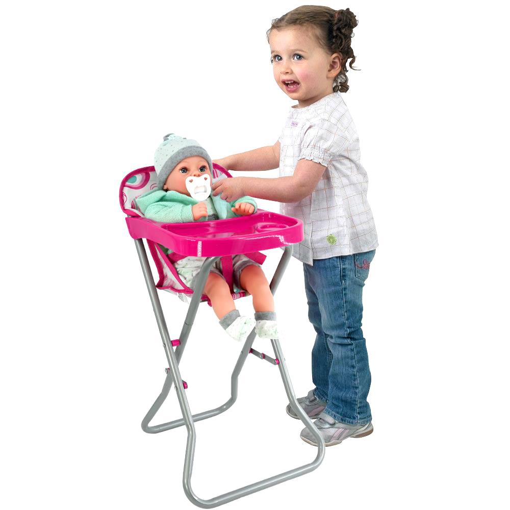 "Baby in pink outfit, blue shoes on high chair." - The Magic Toy Shop