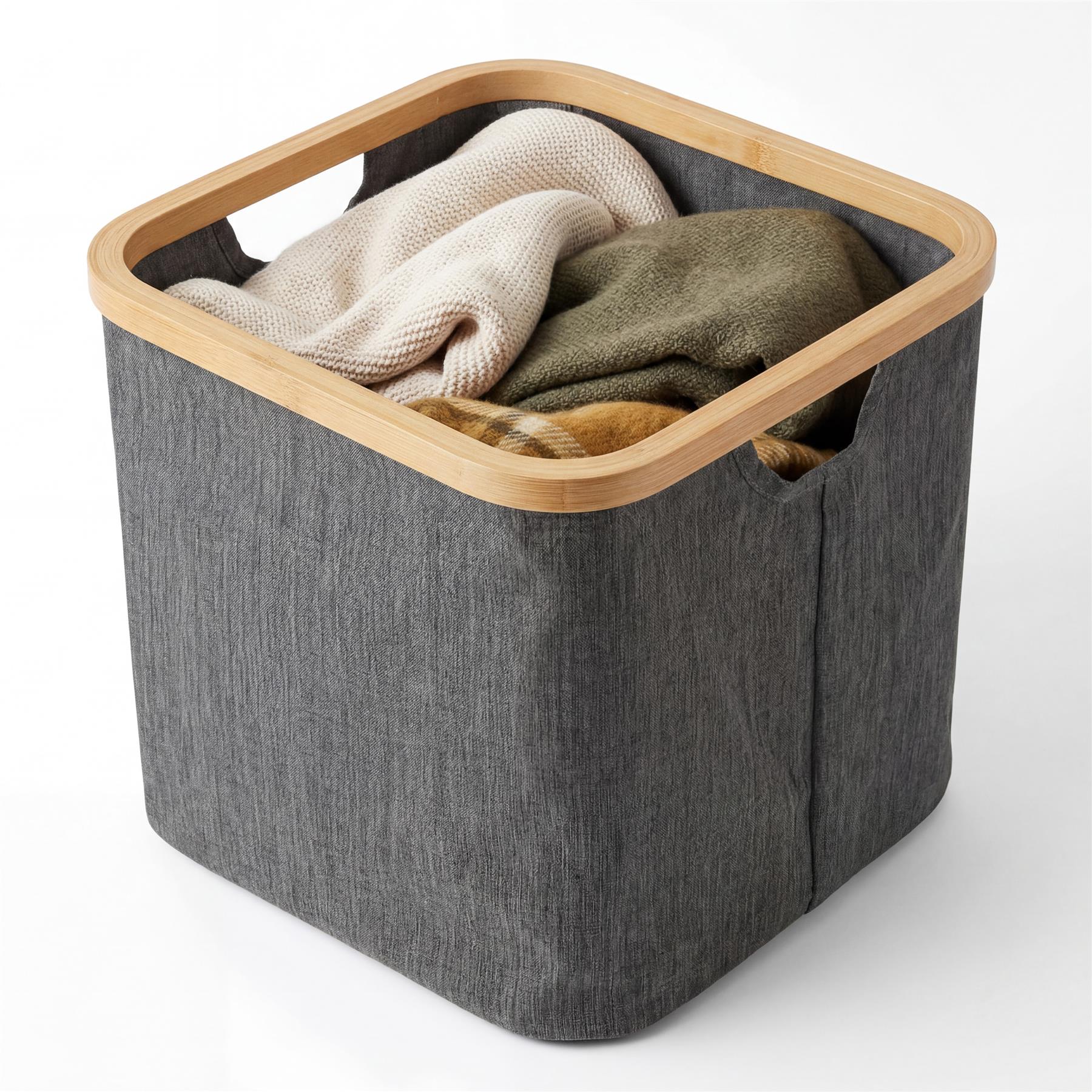 Gray fabric laundry hamper with a wooden rim, partially filled with folded off-white and olive garments.
