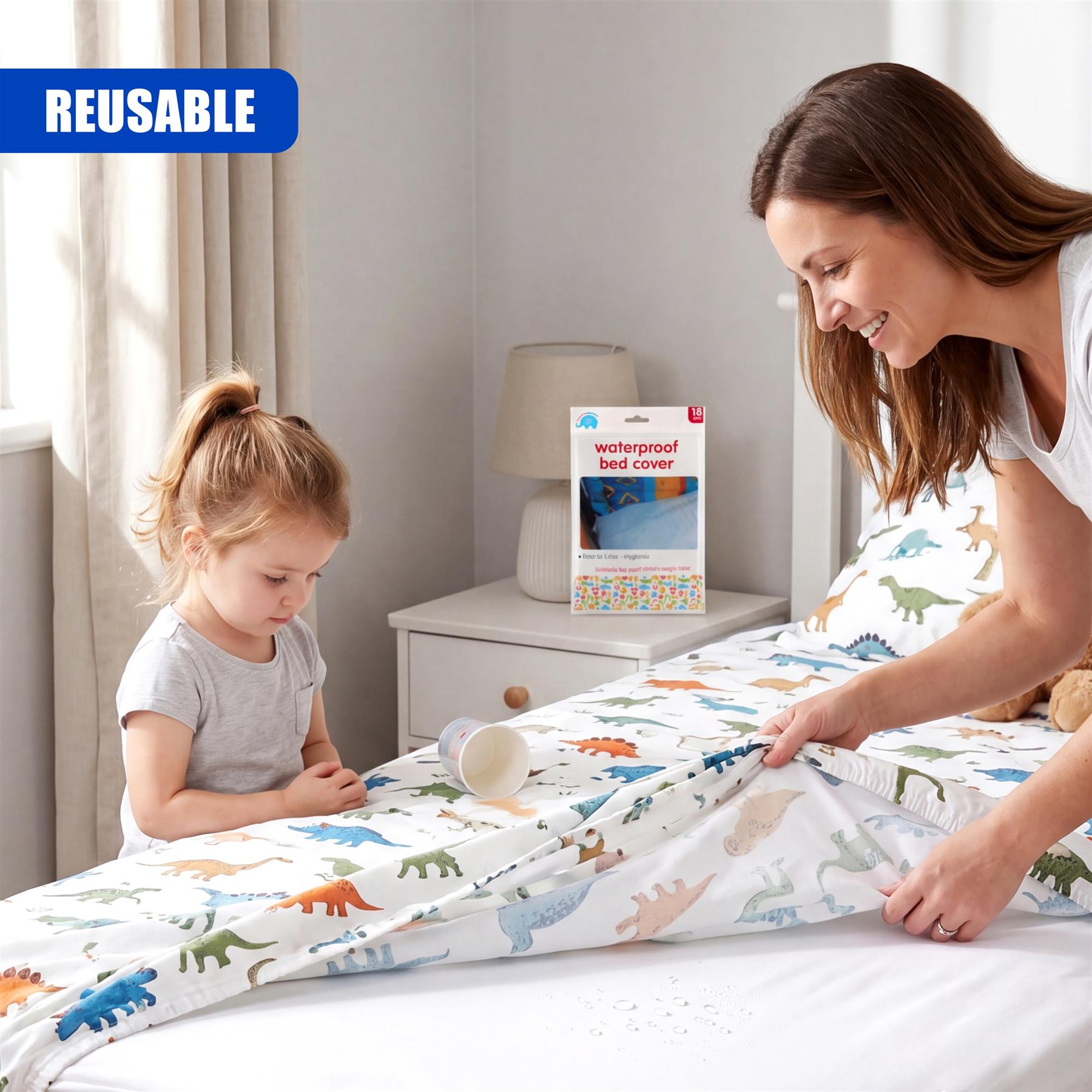 A waterproof dinosaur print bed cover is displayed on a bed with a woman and child present.
