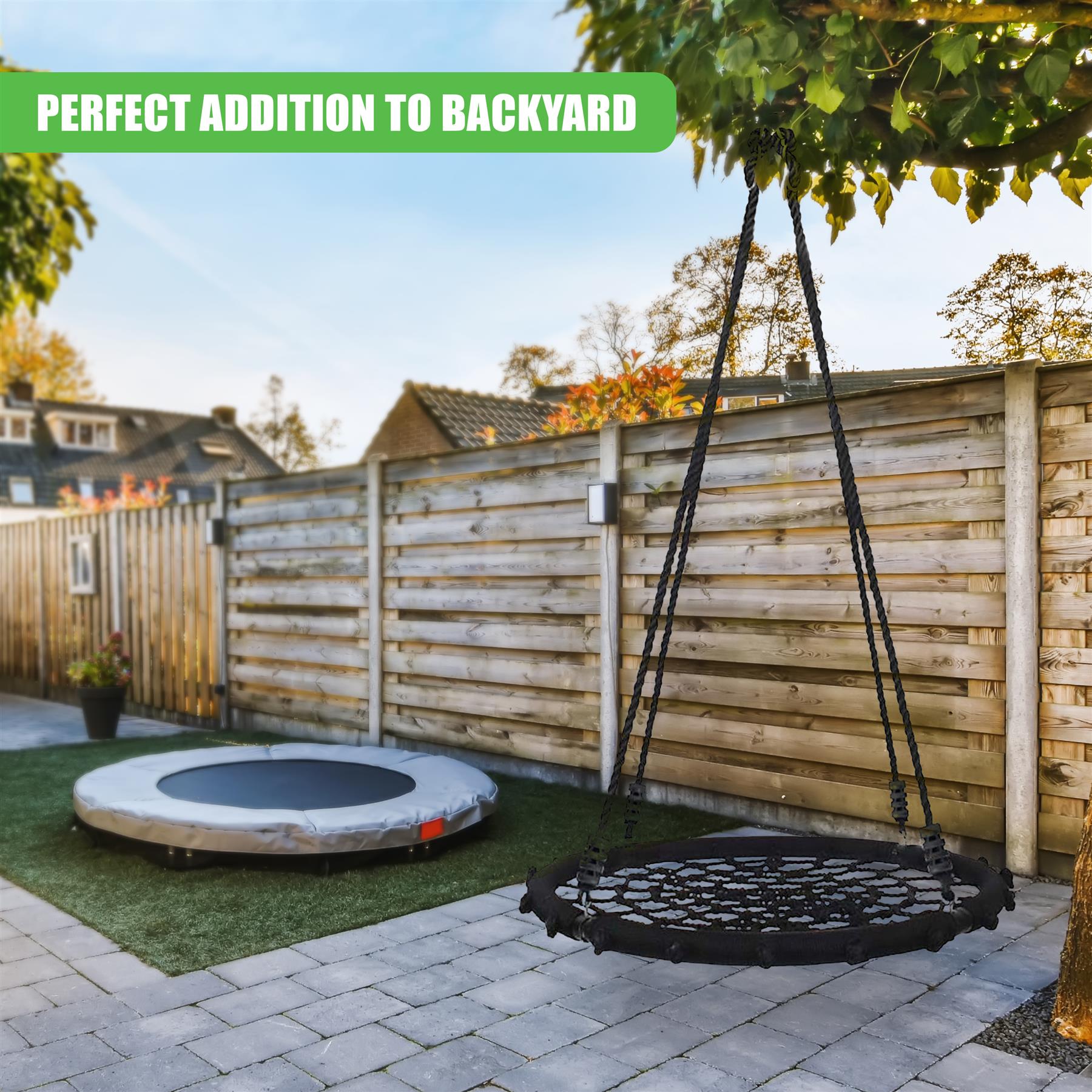 Outdoor backyard view featuring a hanging swing and round nest swing on artificial grass.