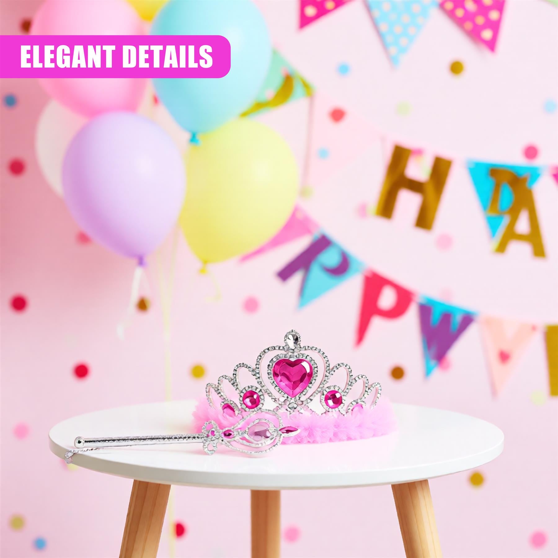 A tiara with a heart-shaped gemstone at its center, surrounded by a delicate filigree design. The tiara is placed on a small, white table, with a pink feathered crown below it. The background is a soft, pastel pink, with a few colorful balloons and a "Happy Birthday" banner. - The Magic Toy Shop