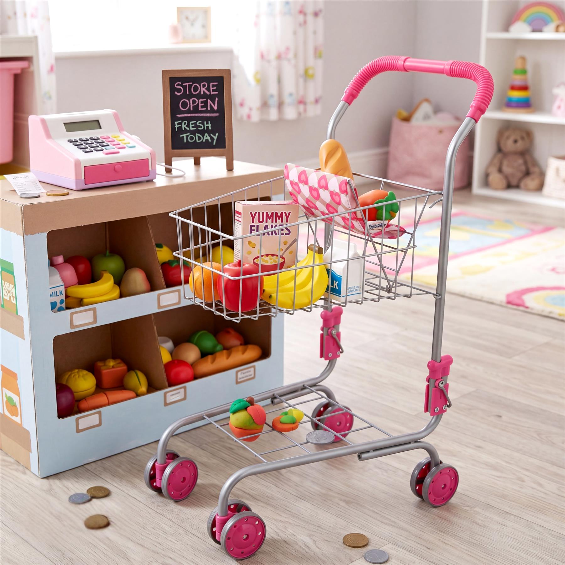 Metal shopping trolley with pink handle and cart filled with colorful play food items.