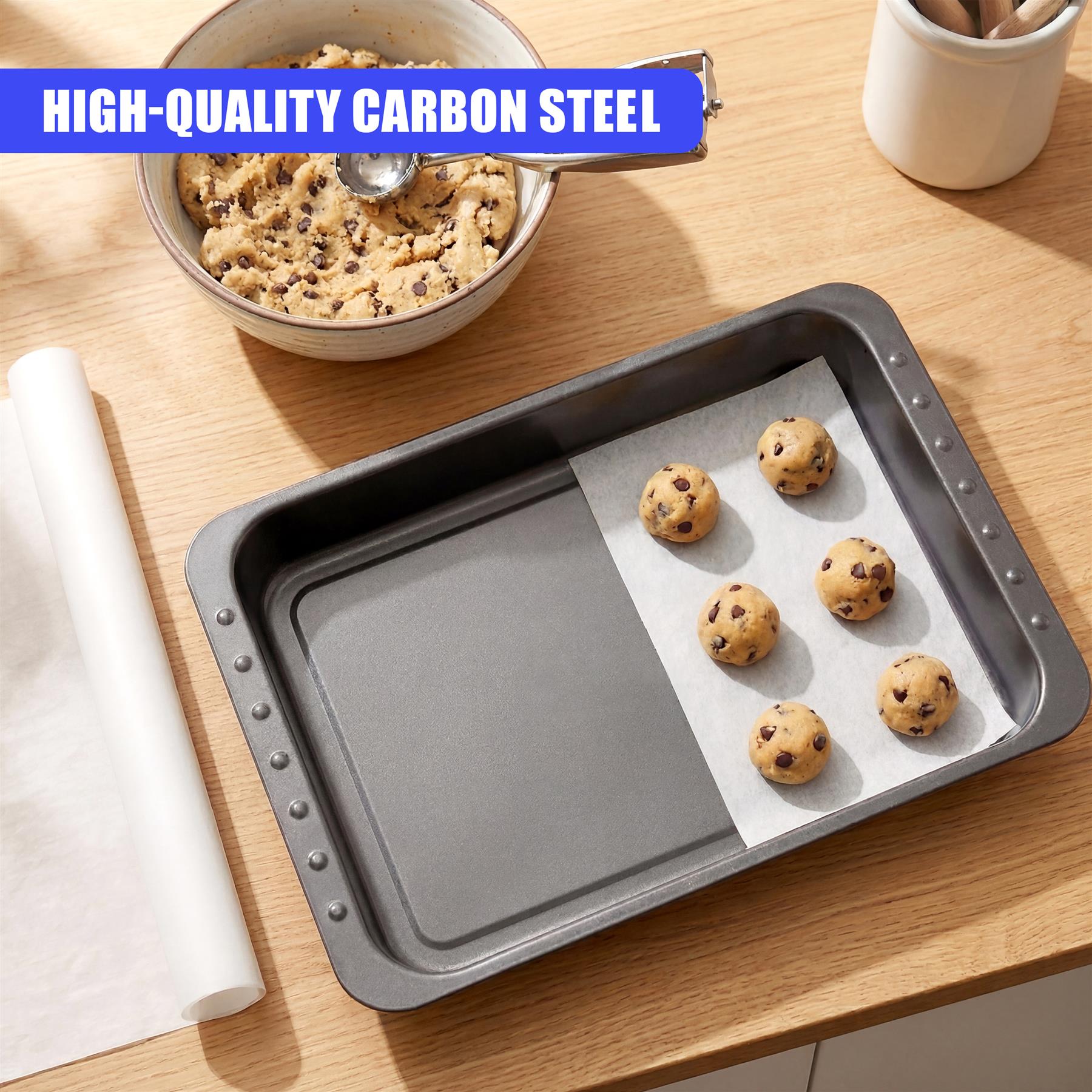 A gray roasting tin with a removable section holds baked goods on a piece of parchment paper.