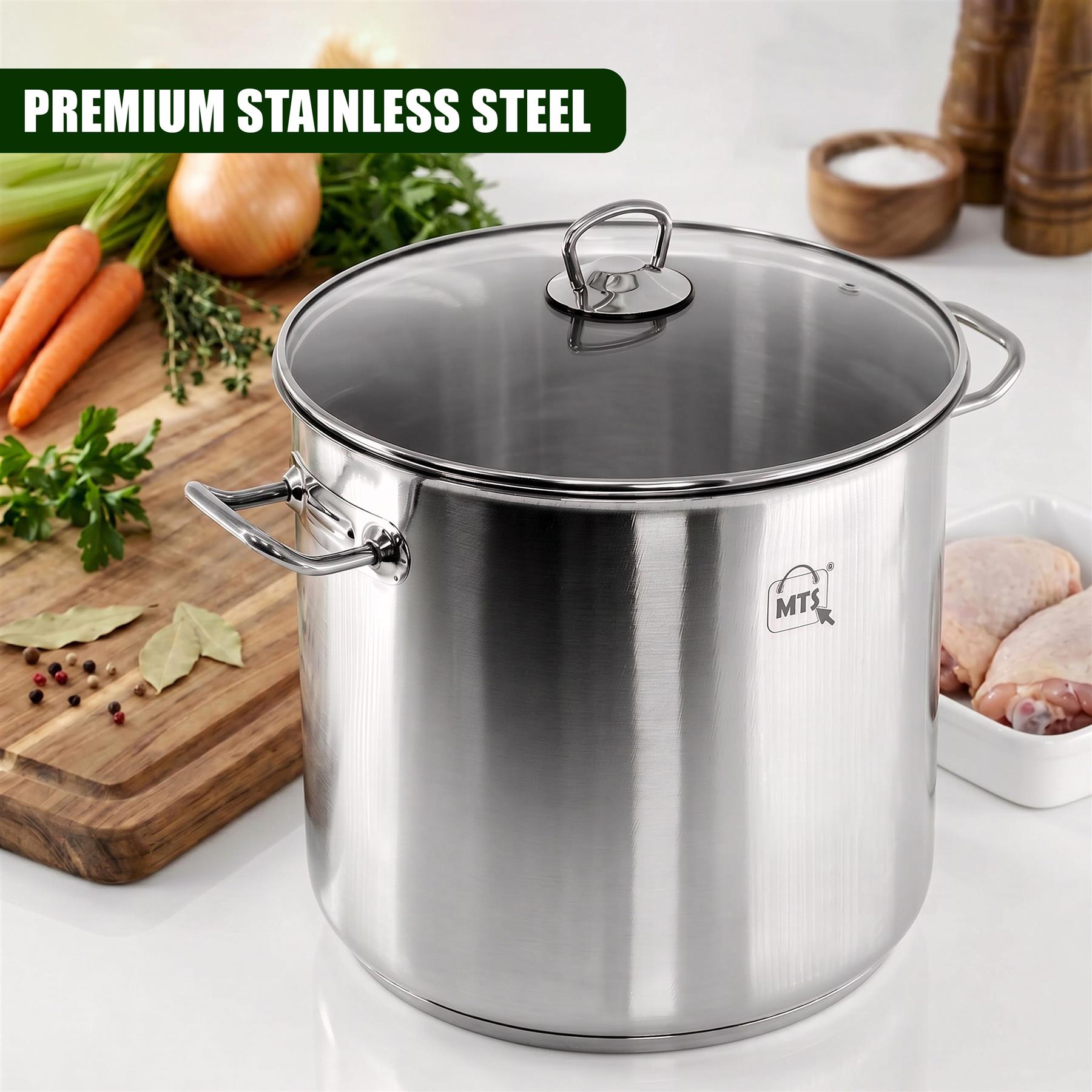 Large metal stock pot with glass lid shown on a wooden board with carrots, onions, and green herbs.