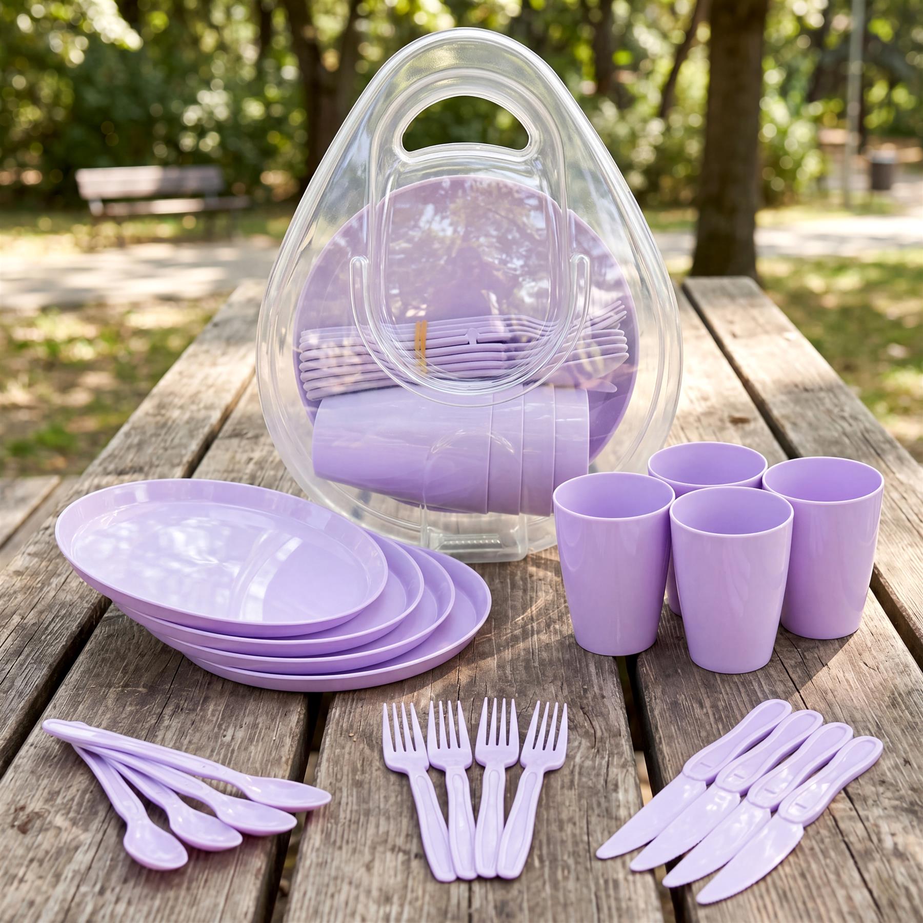 Purple plates, cups, and various purple utensils are arranged with a clear carrying container on wood.