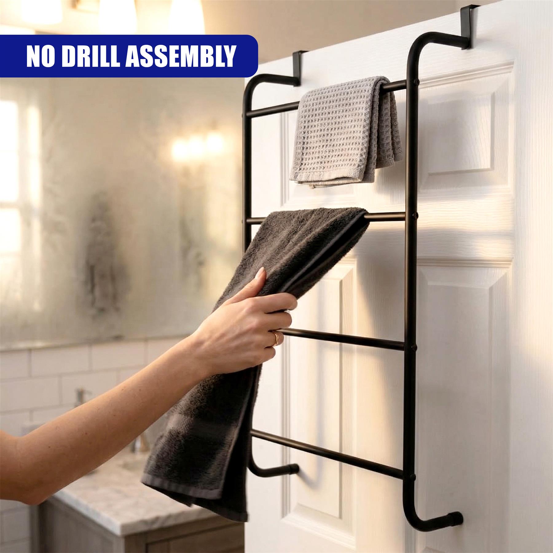 Black ladder-style towel rack hangs on a white door, holding folded gray and white towels.