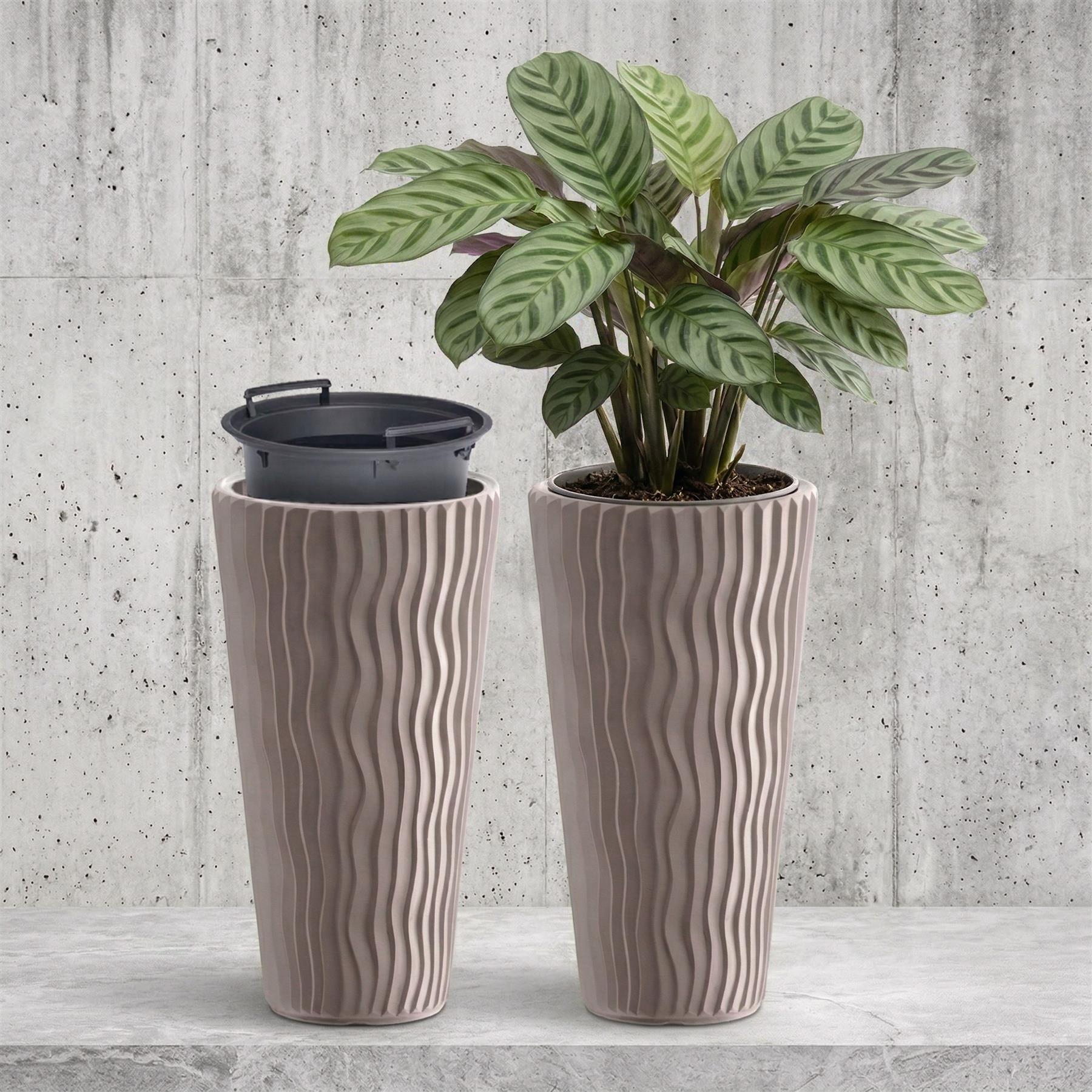 Two vertical ribbed mocha brown pots: one holds a leafy houseplant, and the other holds a dark inner container.