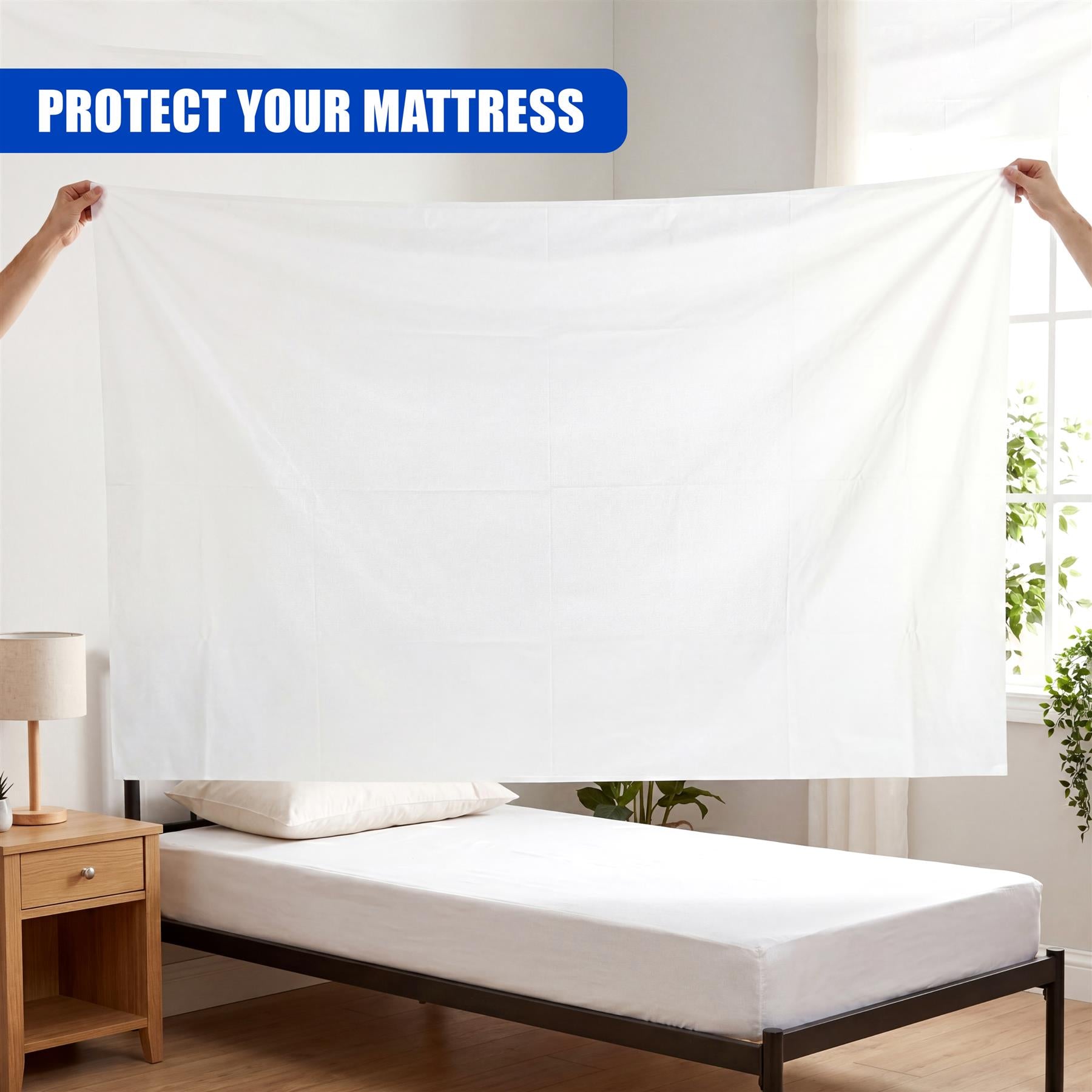 Full-length white bed cover displayed over a simple dark metal bed frame.