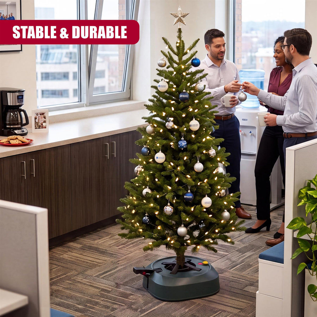 A stable GEEZY Christmas tree stand with a water reservoir is displayed in an office setting