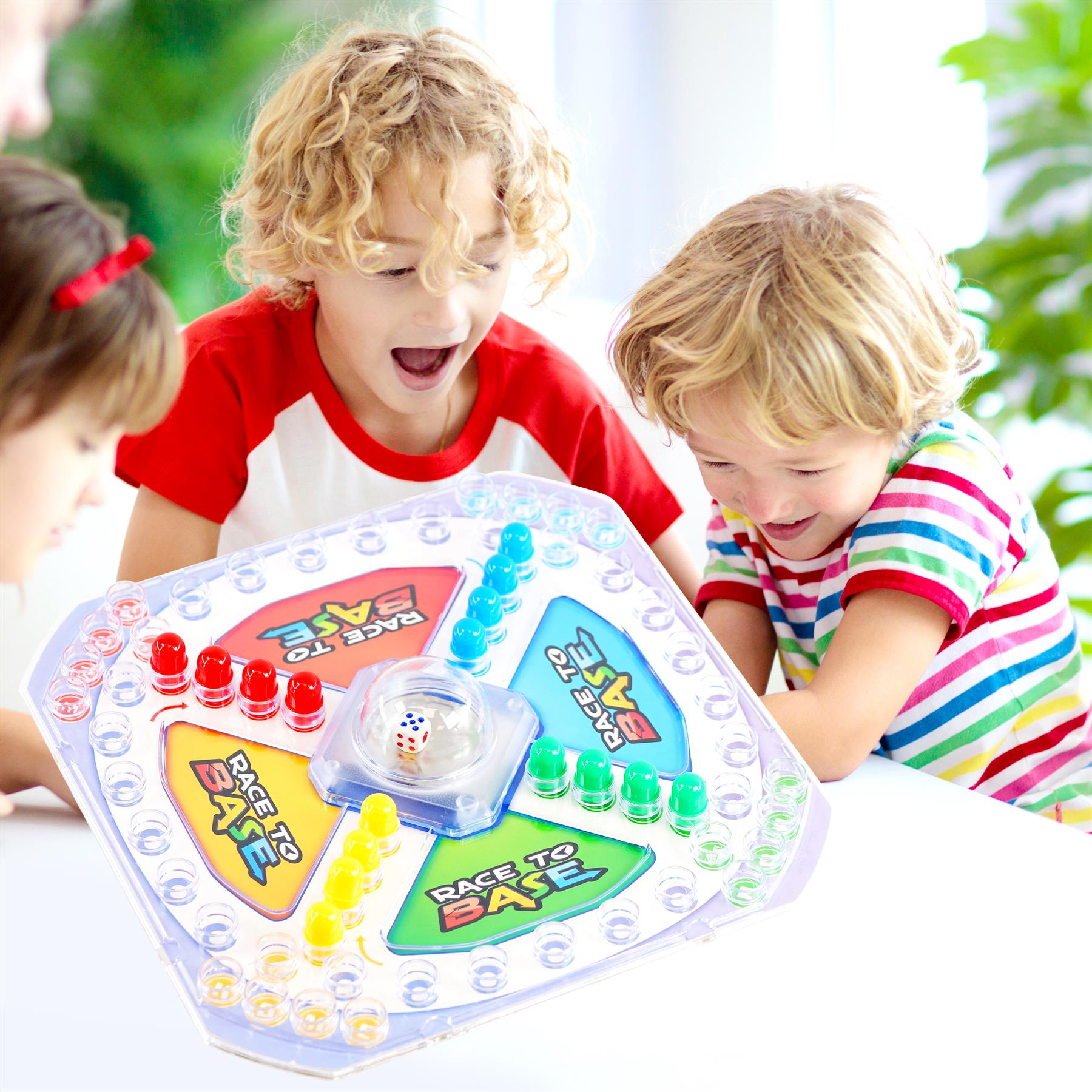 Board game board with plastic tokens, titled Race To Base, and colorful gameplay components for multiple players.