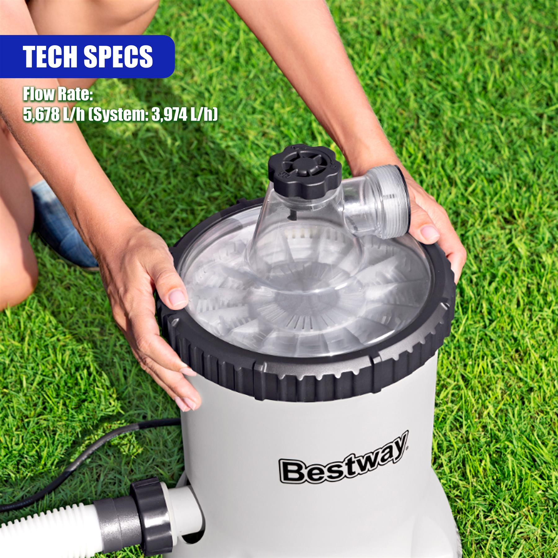 Hands holding the circular filter housing of a white Bestway pool pump unit on green grass.