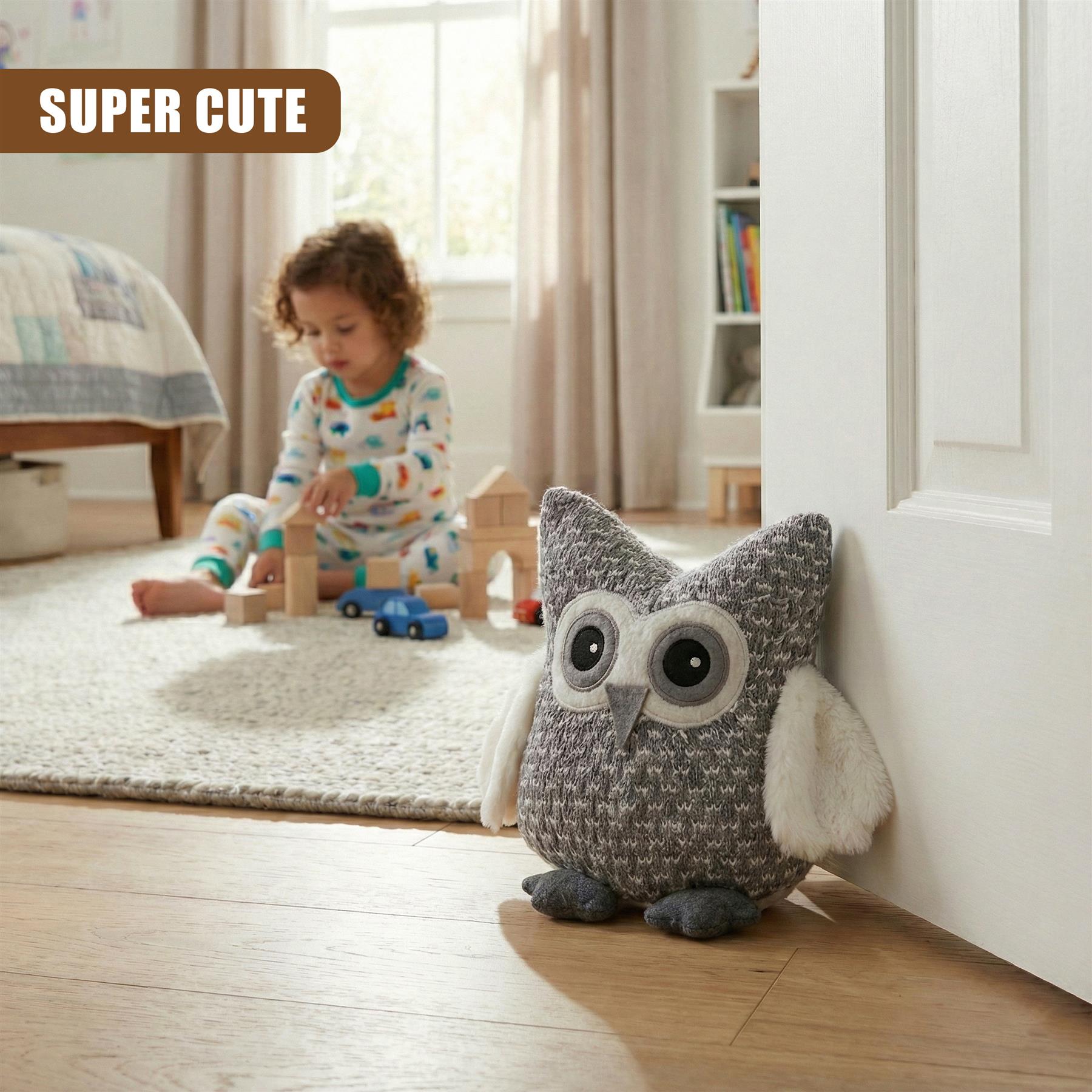 A child sits on a rug, playing with blocks. In the foreground, a grey and white owl plush toy, with big round eyes, sits on the floor, peeking out from behind a door. - The Magic Toy Shop
