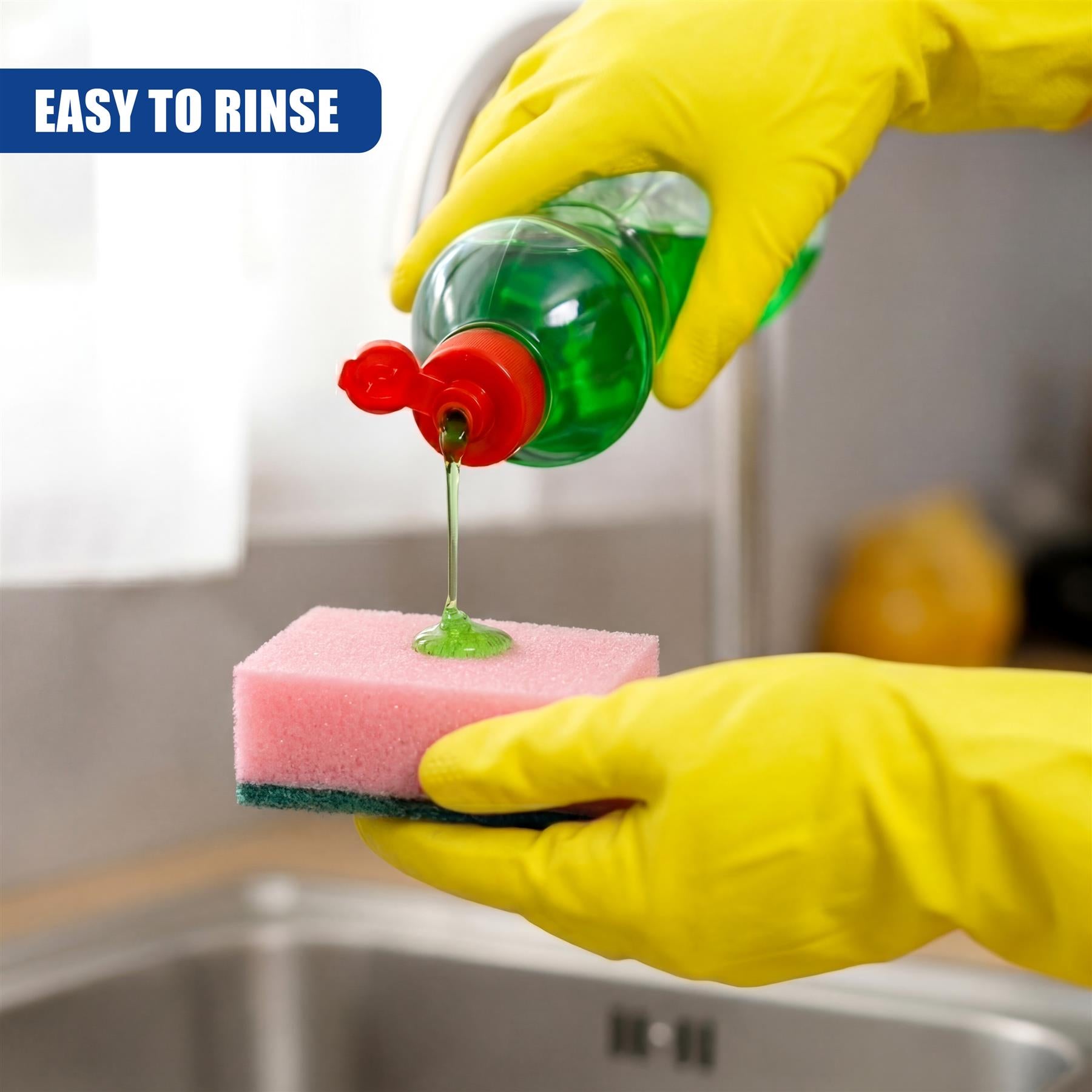 A green soap bottle dispenses liquid onto a pink and green cleaning sponge being held by hands.