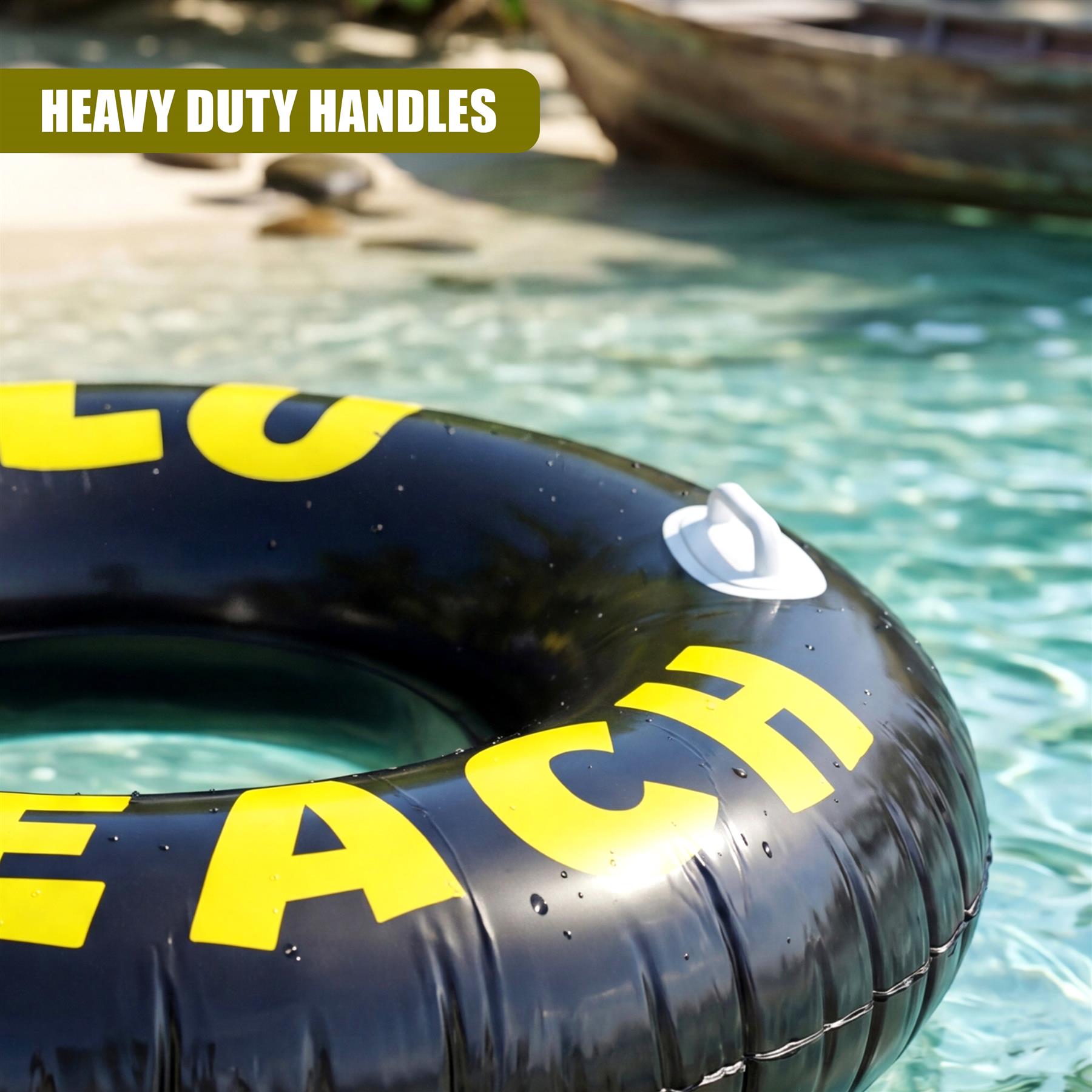Black inner tube ring with yellow lettering spelling "LO BEACH" floats in shallow water.